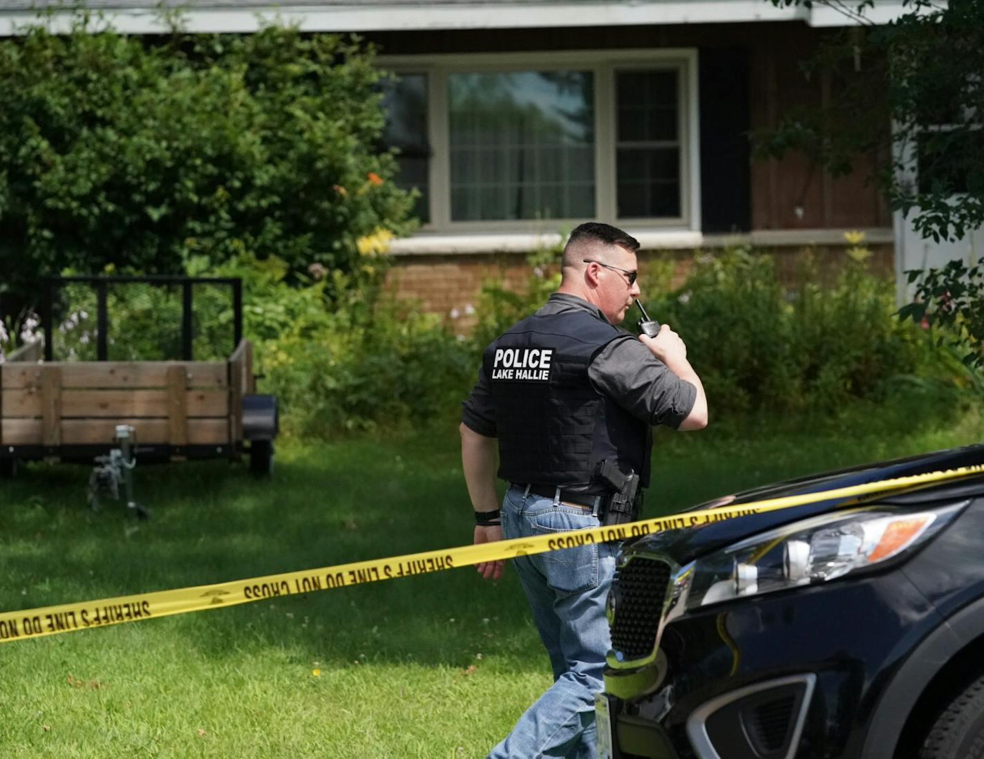 Police work outside a home Monday, July 29, 2019, in Lake Hallie, Wis., following a shooting the night before. Authorities in northwestern Wisconsin say shootings at two homes have left five people dead, including the suspected shooter, and two others injured.