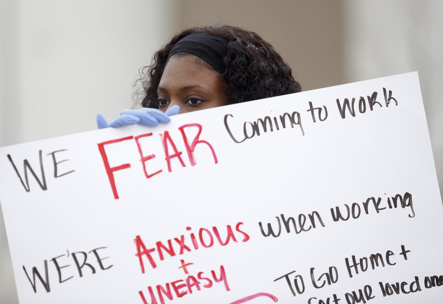 Amazon employee, Brela Flemming, 20, of Redford, holds a sign alongside her coworkers while on strike, Wednesday, April 1, 2020, outside an Amazon Fulfillment Center in Romulus, Mich., Wednesday, April 1, 2020. Amazon, which has come under fire from employees and politicians for not taking sufficient steps to protect workers on the job during the coronavirus pandemic, said it would ramp up safety efforts. (Elaine Cromie/The New York Times)