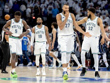 Anthony Edwards (5), Mike Conley (10), Rudy Gobert (27) and Karl-Anthony Towns (32) of the Timberwolves walk off the court at the end of Game 1 of the