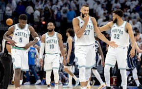 Anthony Edwards (5), Mike Conley (10), Rudy Gobert (27) and Karl-Anthony Towns (32) of the Timberwolves walk off the court at the end of Game 1 of the