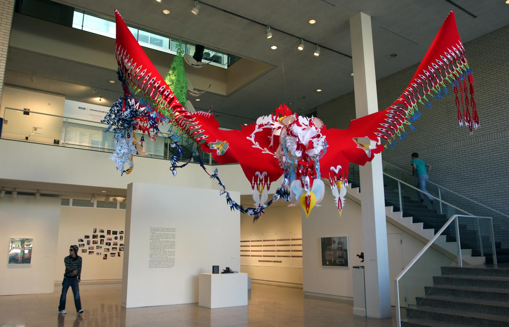 Paper/felt chinese dragon flying over the Jerome Artists exhibition at the Minneapolis College of Art and Design gallery.
