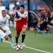 FC Dallas defender Ryan Hollingshead plays the ball while Minnesota United forward Miguel Ibarra chases during a match last season.
