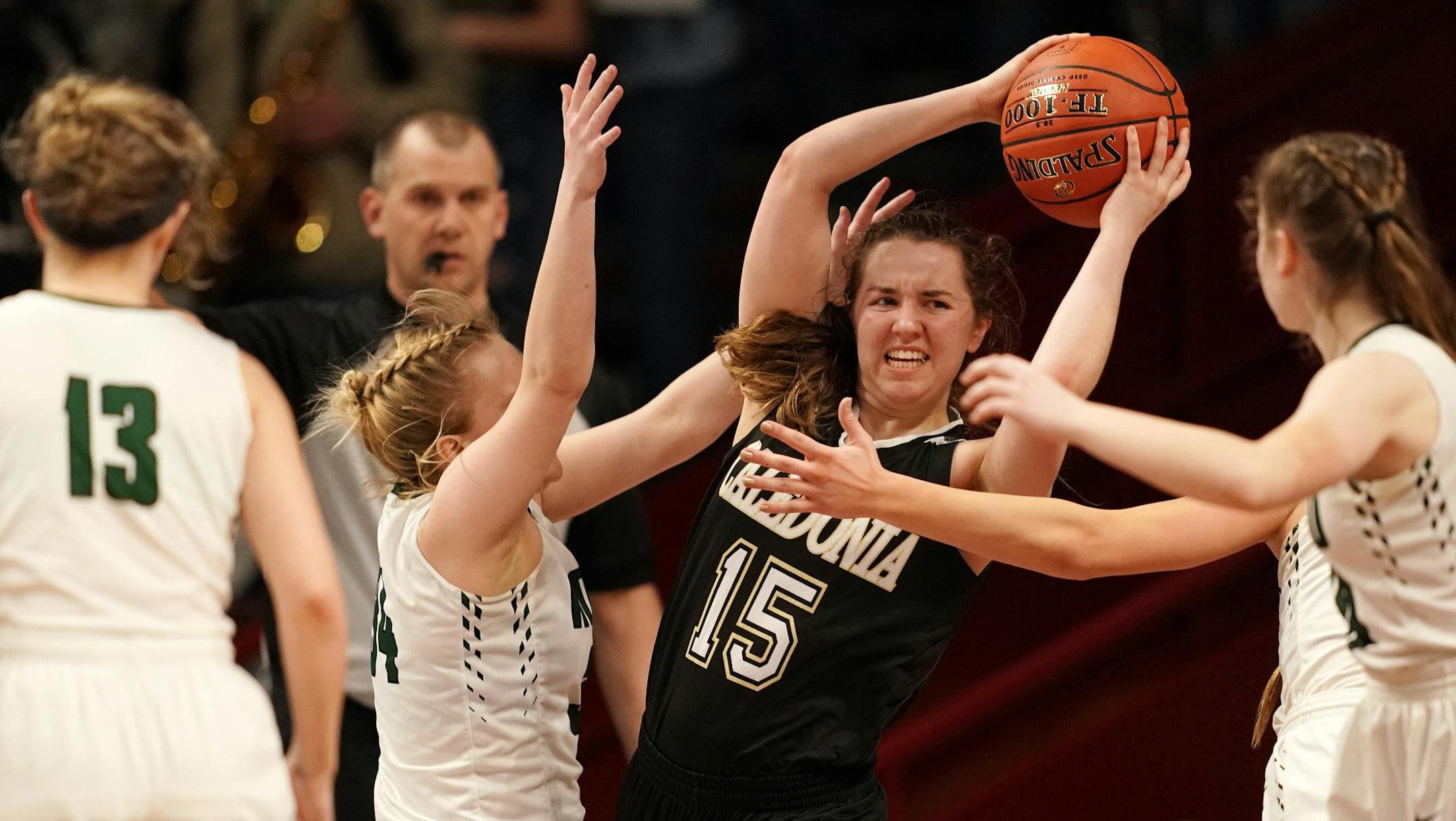 Caledonia guard Ashley Schroeder (15) looked for a teammate to pass the ball to as Roseau forward Emma Waling (34) pressured her in the second half. ] ANTHONY SOUFFLE • anthony.souffle@startribune.com Caledonia High School played Roseau High School in a MSHSL Class 2A semifinal girls' basketball game Friday, March 15, 2019 at Williams Arena in Minneapolis.