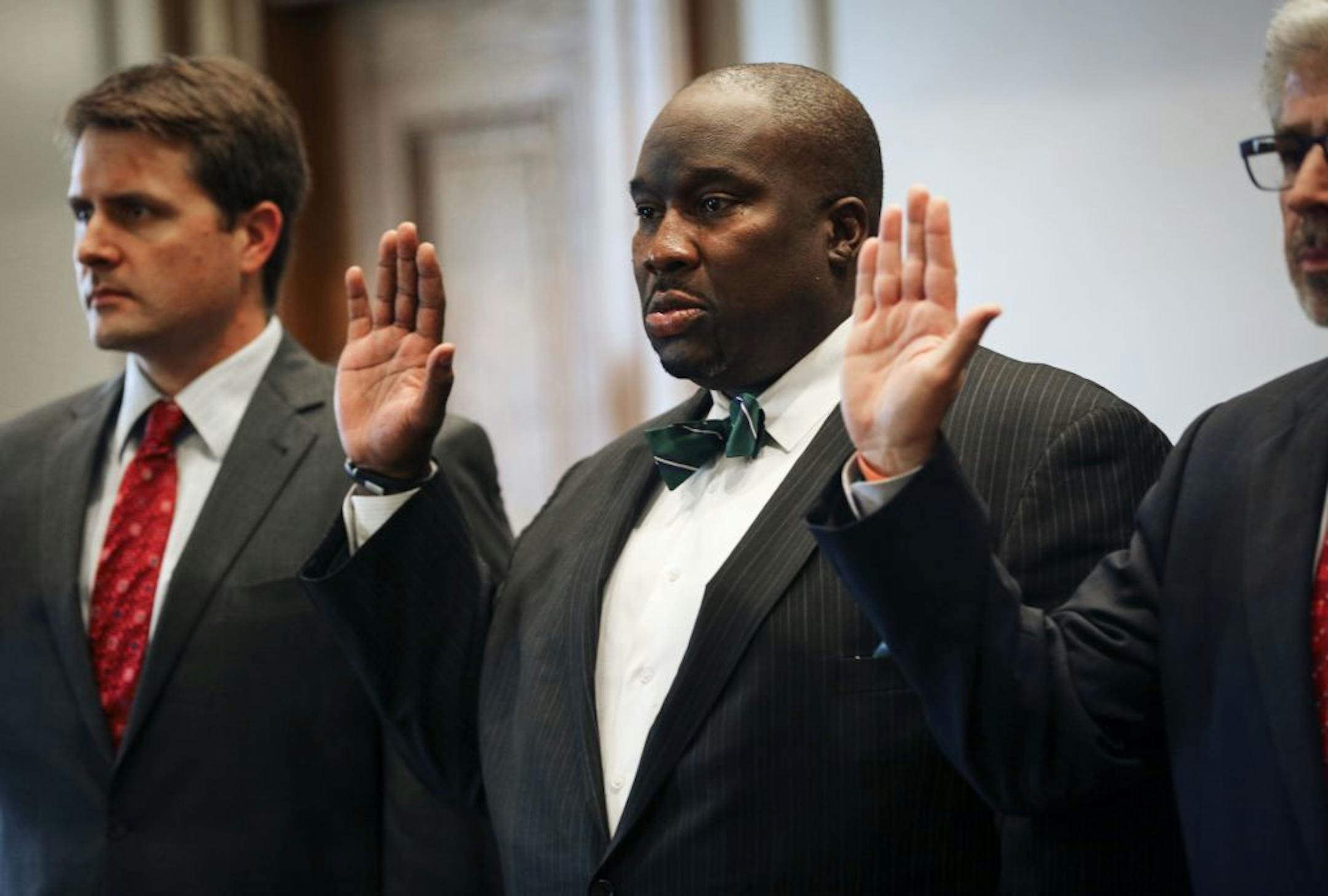 Sen. Jeff Hayden is sworn in standing between his lawyers during a Minnesota Senate committee hearing, Wednesday, Oct. 22, 2014 at the State Capitol in St. Paul, Minn. A state Senate ethics committee deliberated for more than two hours Wednesday without coming to a consensus on how to proceed on a GOP ethics complaint against DFL Sen. Jeff Hayden of Minneapolis.