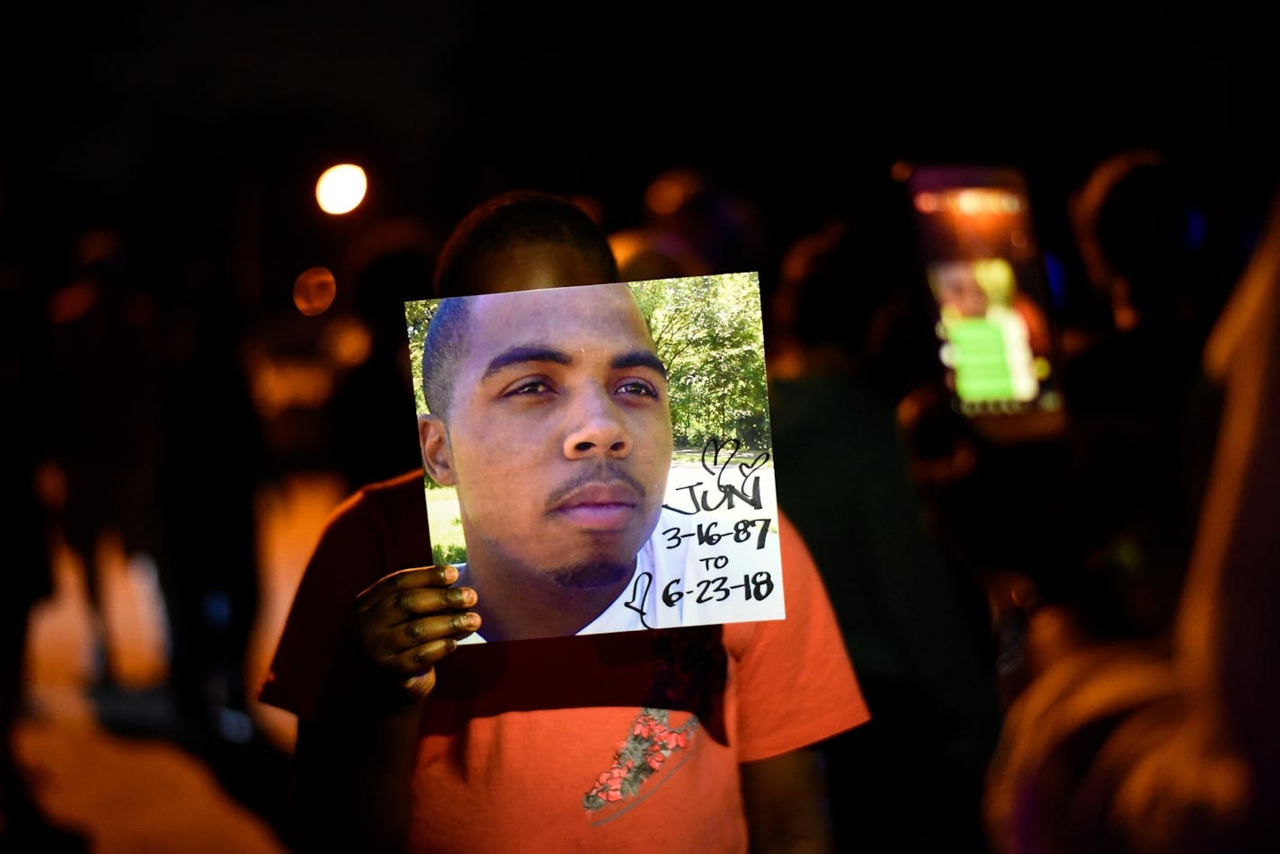 Isaiah Brown, 11, held a photo of Thurman Blevins, the man killed by Minneapolis police.