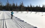 A cross-country skiers crosses a pond on the Beaver Dam Trail at Bearskin Lodge, on Minnesota's Gunflint Trail. Photo by Kerri Westenberg/Star Tribune
