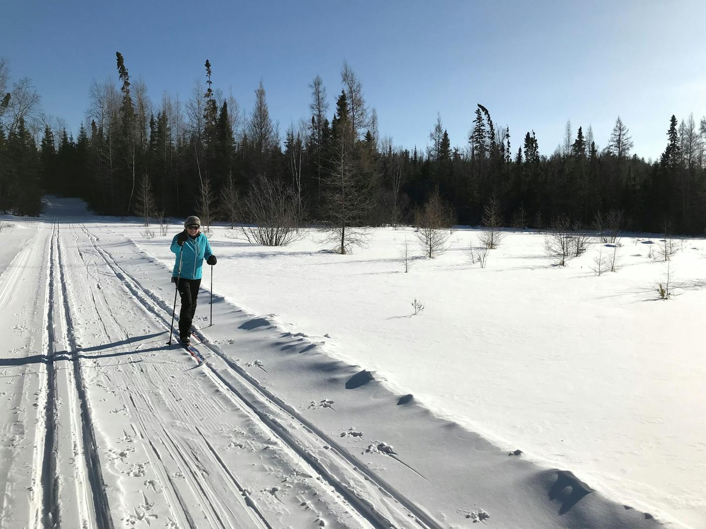 A cross-country skiers crosses a pond on the Beaver Dam Trail at Bearskin Lodge, on Minnesota's Gunflint Trail. Photo by Kerri Westenberg/Star Tribune