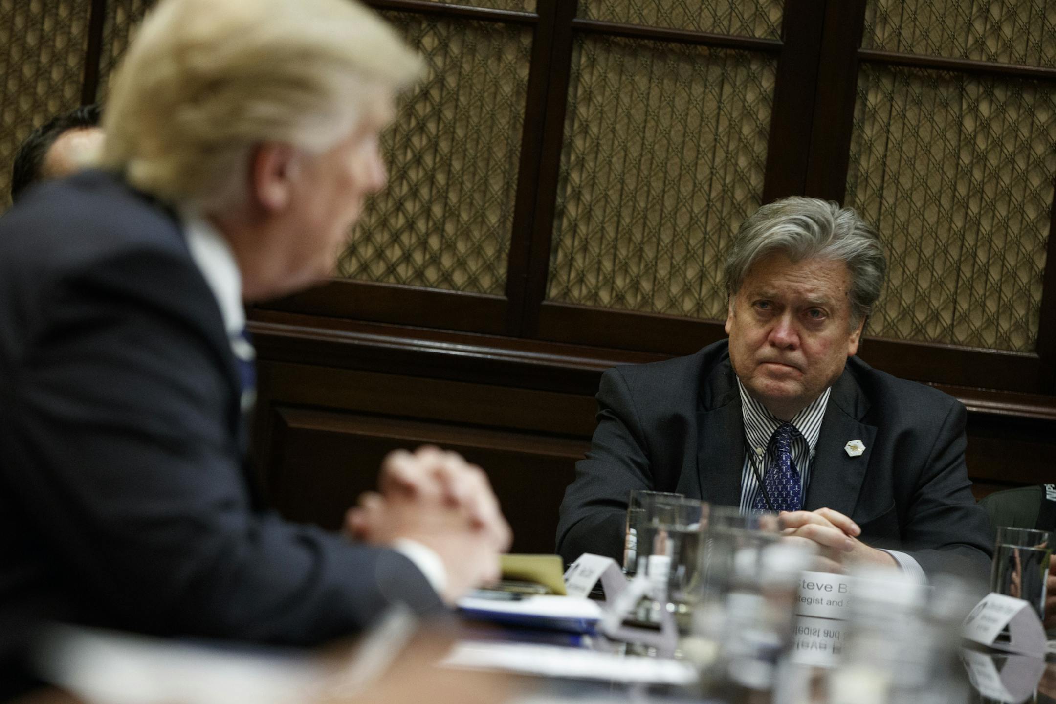 Then-White House Chief Strategist Steve Bannon listens as President Donald Trump speaks during a meeting on cyber security in the Roosevelt Room of the White House in Washington, Tuesday, Jan. 31, 2017. (AP Photo/Evan Vucci, File)