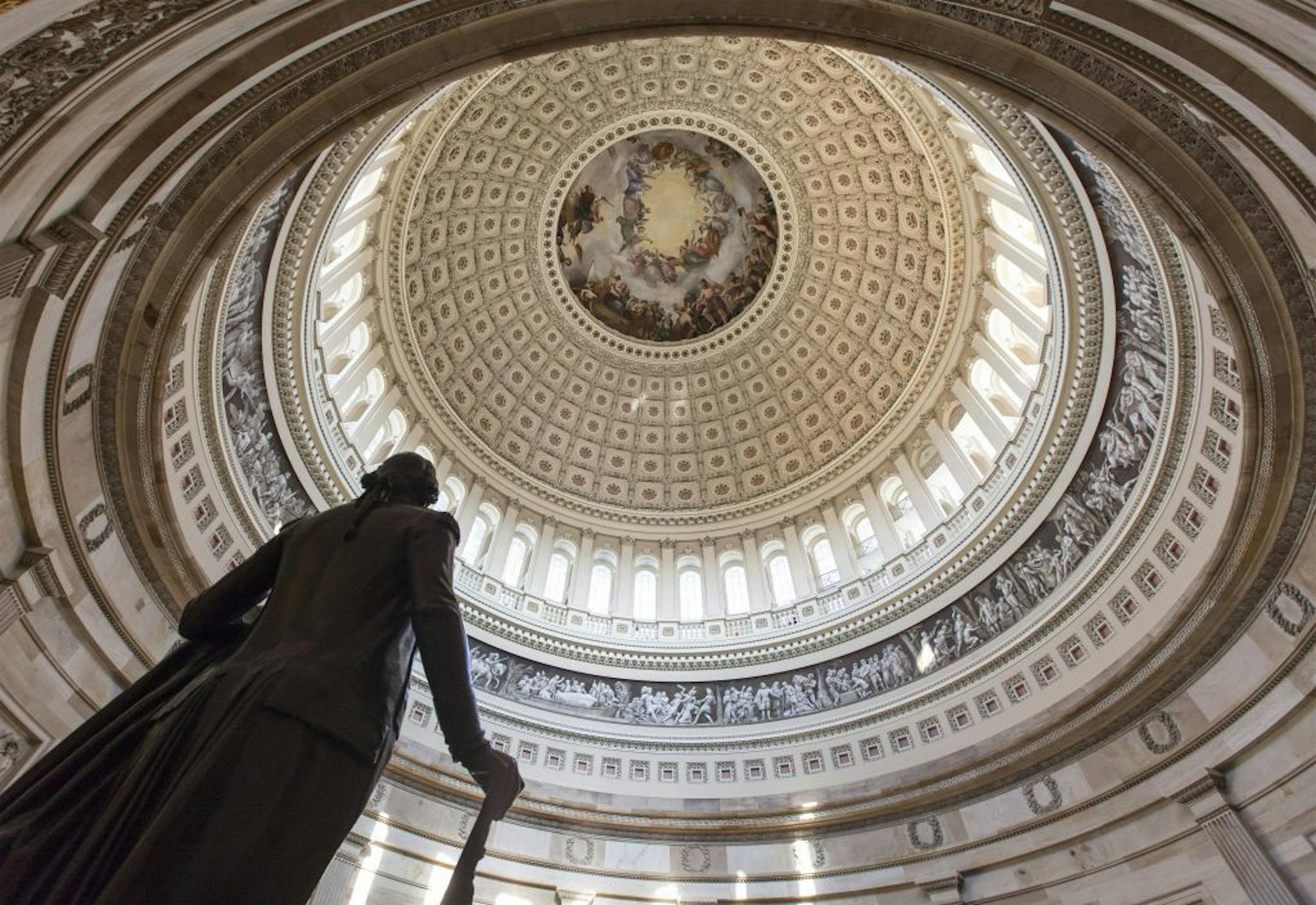 The Capitol Rotunda looms over the statue of George Washington on Capitol Hill in Washington, Monday, Jan. 27, 2014, as the House and Senate resume work in Washington. President Barack Obama will deliver his State of the Union address Tuesday night to a joint session of Congress.