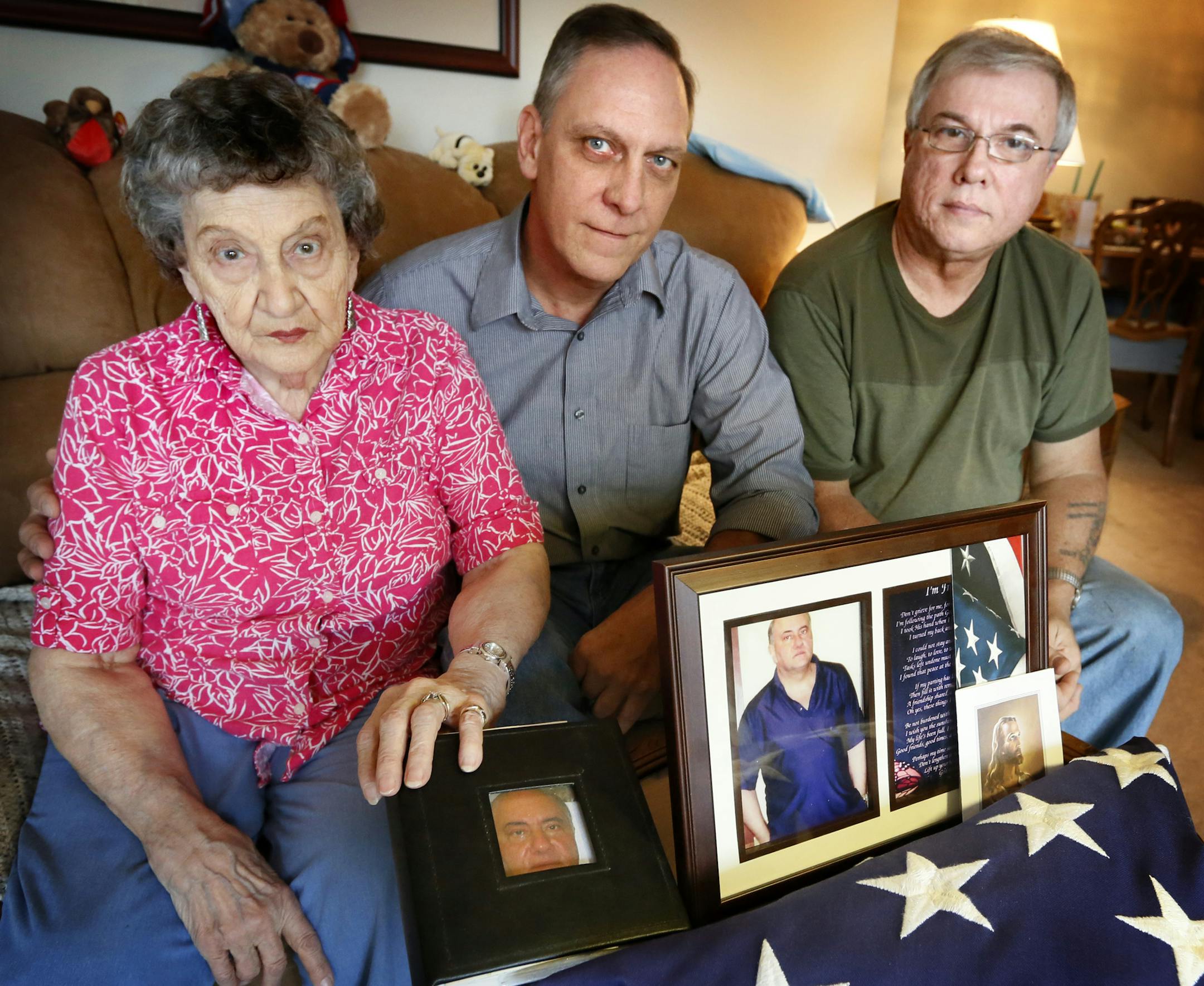 Elaine Bain and her sons Dick and Jim Bain, pose with pictures of her son, Jerry, who died of a drug overdose at the Minneapolis Veterans Home.