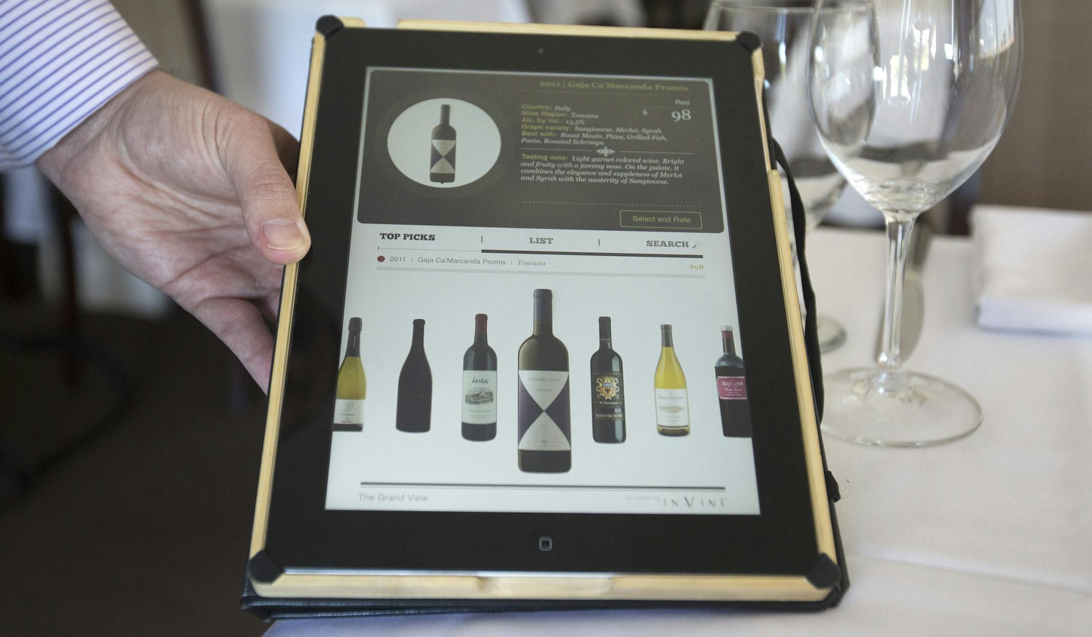 Employee Jaime Hunter displays the wine list on an Apple iPad at the Mount Hamilton Grandview Restaurant in San Jose, Calif., on March 24, 2016. Sales of Apple's iPad have been falling lately, but the iPad is finding a surprising new use outside consumer's couches as a growing number of retailers and restaurants are using the device instead of traditional registers and merchant payment terminals. (Patrick Tehan/Bay Area News Group/TNS) ORG XMIT: 1182818