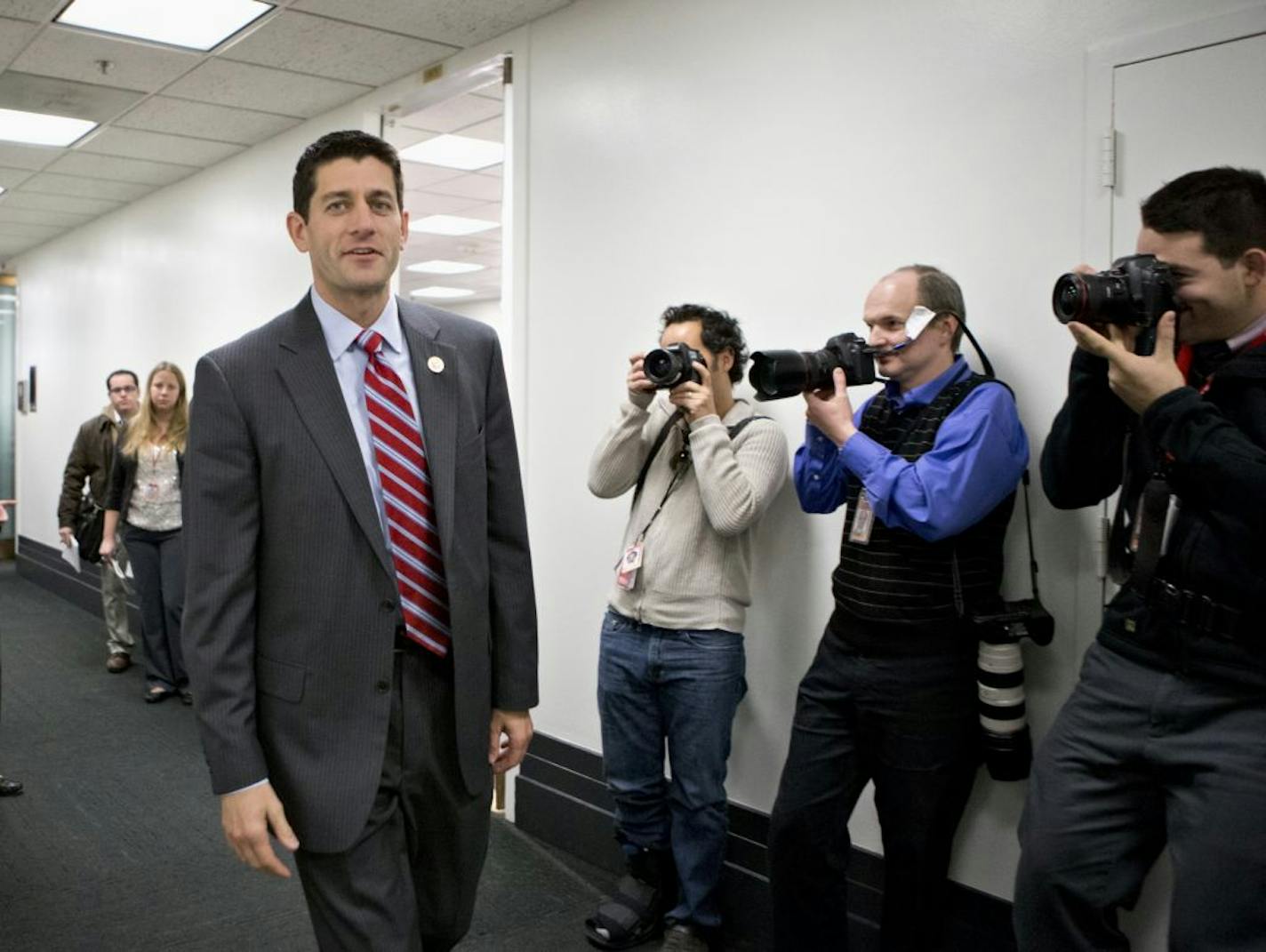 FILE - This Nov. 28, 2012 file photo shows House Budget Committee Chairman Rep. Paul Ryan, R-Wis. walking on Capitol Hill in Washington. House Republicans say they may seek a short-term extension of the government's debt limit in the next few weeks, a move that would avoid an immediate default by the Treasury. Ryan provided no details on the duration of any extension or conditions that might be attached as he appeared at a news conference during a break at a three-day retreat of the rank and fil