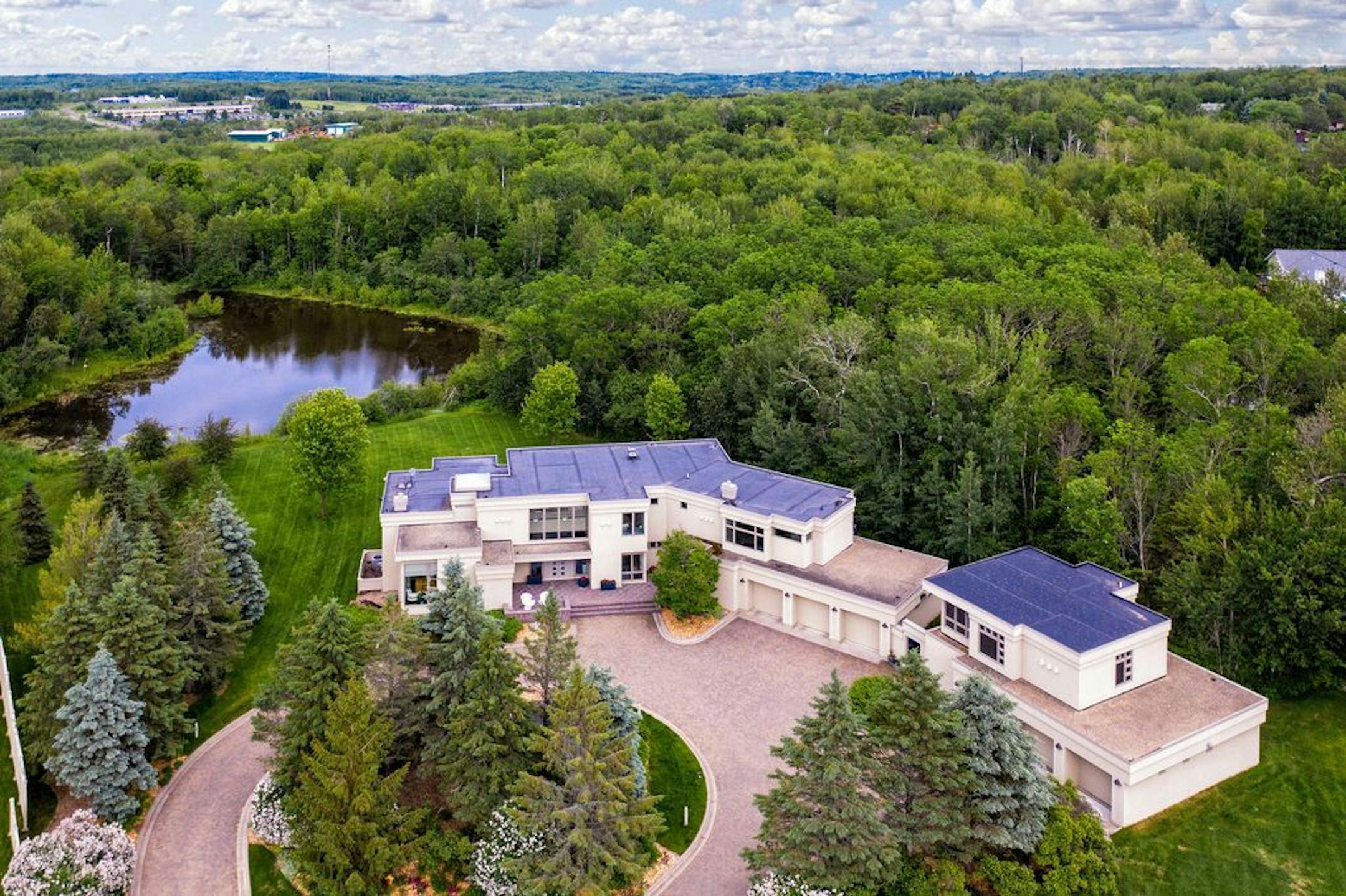 Aerial view of the home, acreage and pond.