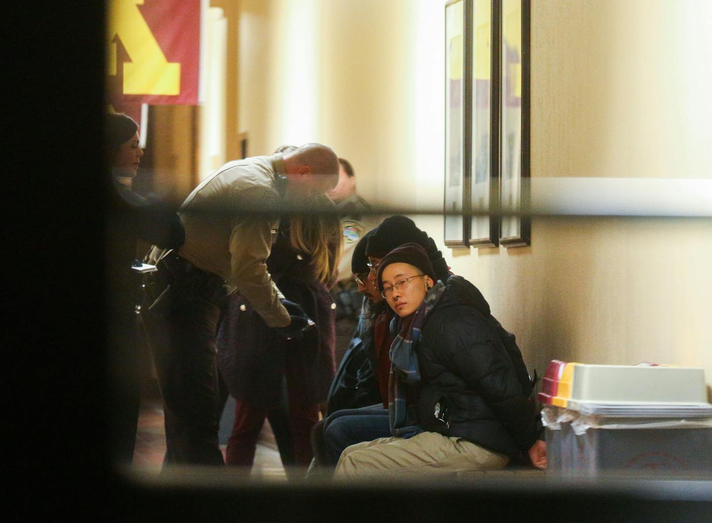 University of Minnesota police and Hennepin County Sheriff's deputies prepare protesters for transport. ] Mark Vancleave - mark.vancleave@startribune.com * Student protesters with the group Who's Diversity occupied the offices of University of Minnesota president Eric Kaler on Monday, Feb. 9, 2015.