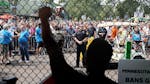 Rashad Turner, lead organizer for Black Lives Matter St. Paul, raised his arm at the front gate of the Minnesota State Fair while chanting with hundre