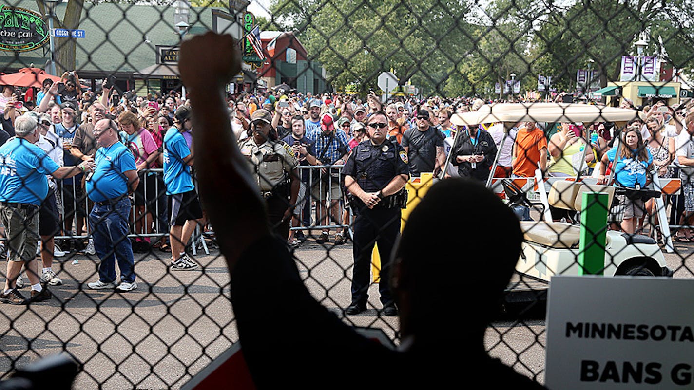 Rashad Turner, lead organizer for Black Lives Matter St. Paul, raised his arm at the front gate of the Minnesota State Fair while chanting with hundreds of other protesters.