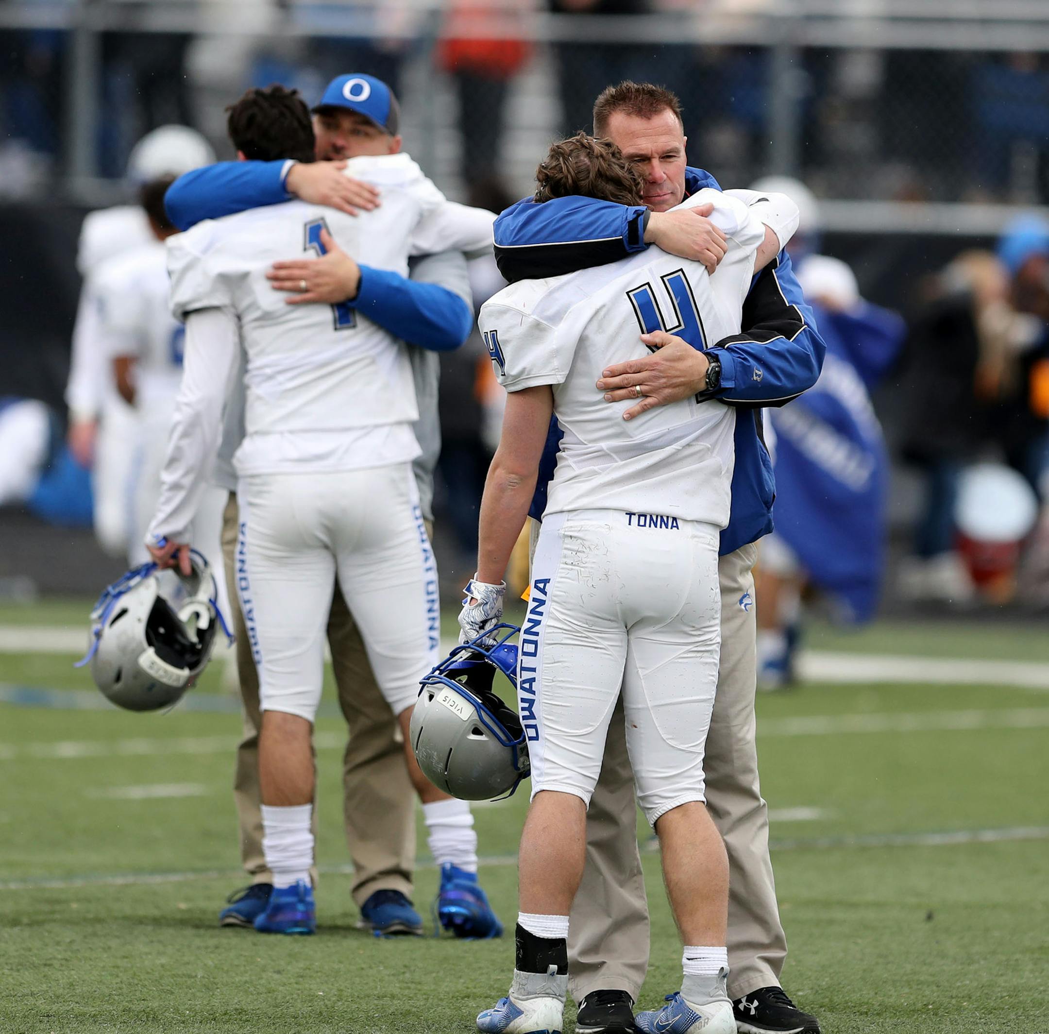 Owatonna receivers Ethan Walter (4) and Matt Williams (1) get some support from coaches after their 21-0 loss to St. Thomas Academy.] DAVID JOLES • david.joles@startribune.com Class 5A football state quarterfinal, Owatonna vs. St. Thomas Academy, rematch of Class 5A Prep Bowl Saturday, Nov. 9, 2019 at Woodbury High in Woodbury, MN.