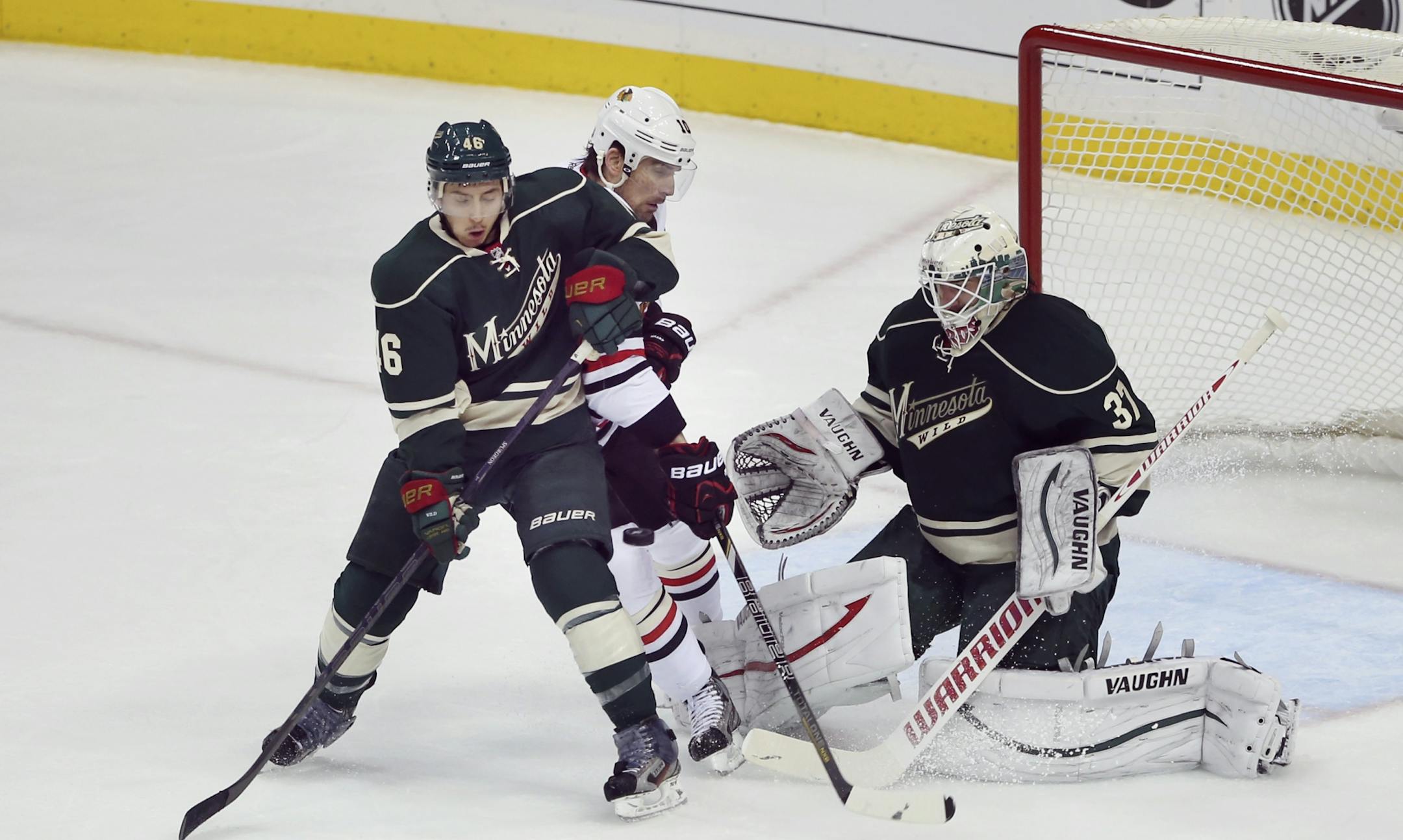 Patrick Sharp tipped an incoming shot in for a goal while being defending by Jared Spurgeon standing in front of Minnesota goal keeper Josh Harding in the first period.The Minnesota Wild faced the Chicago Blackhawks in game four of their NHL Western Conference quarterfinal playoff series Tuesday night, May 7, 2013 at Xcel Energy Center in St. Paul, Minn.