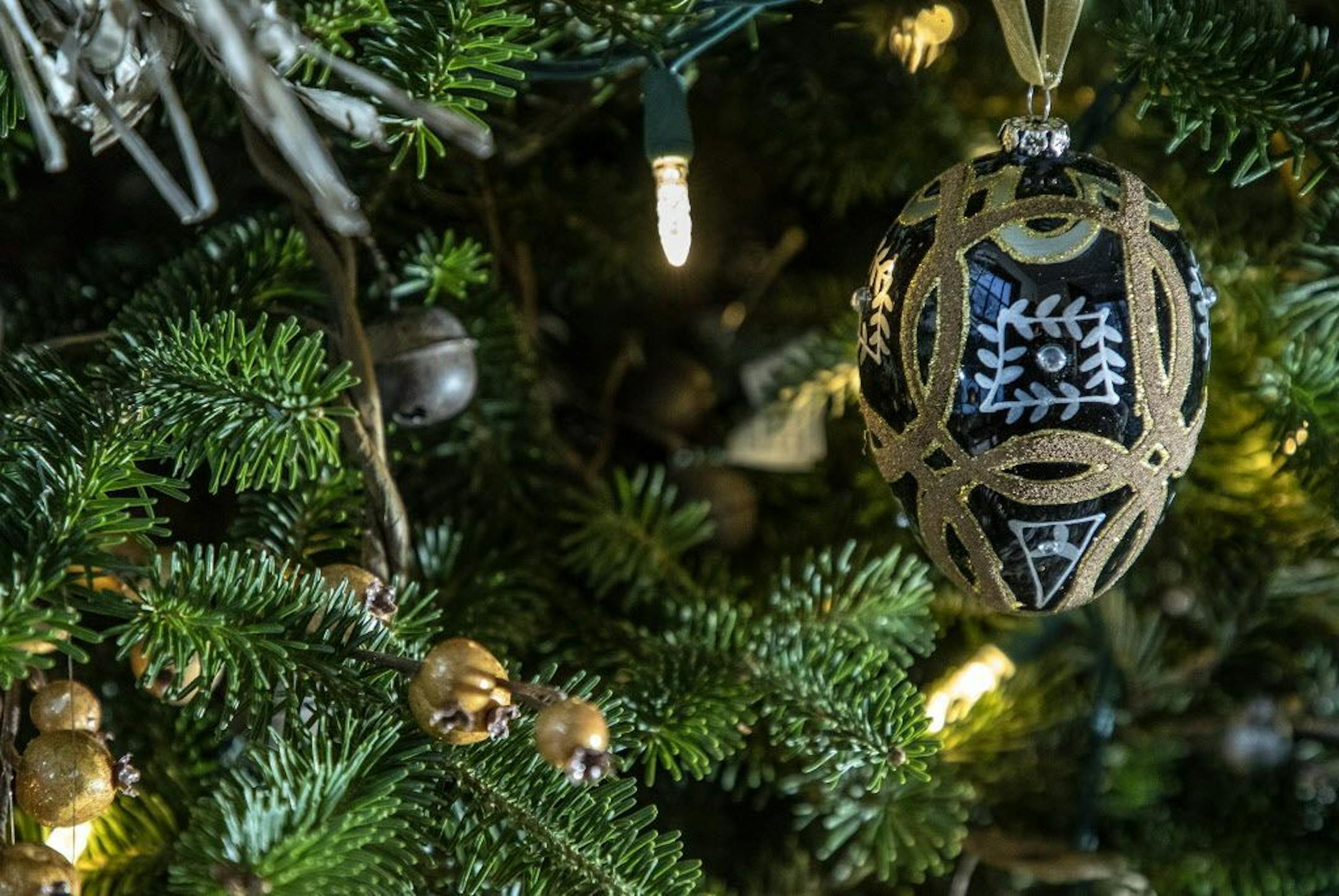 The holiday palette of back, silver, gold and merlot includes unexpected Fabergé-style egg ornaments.
