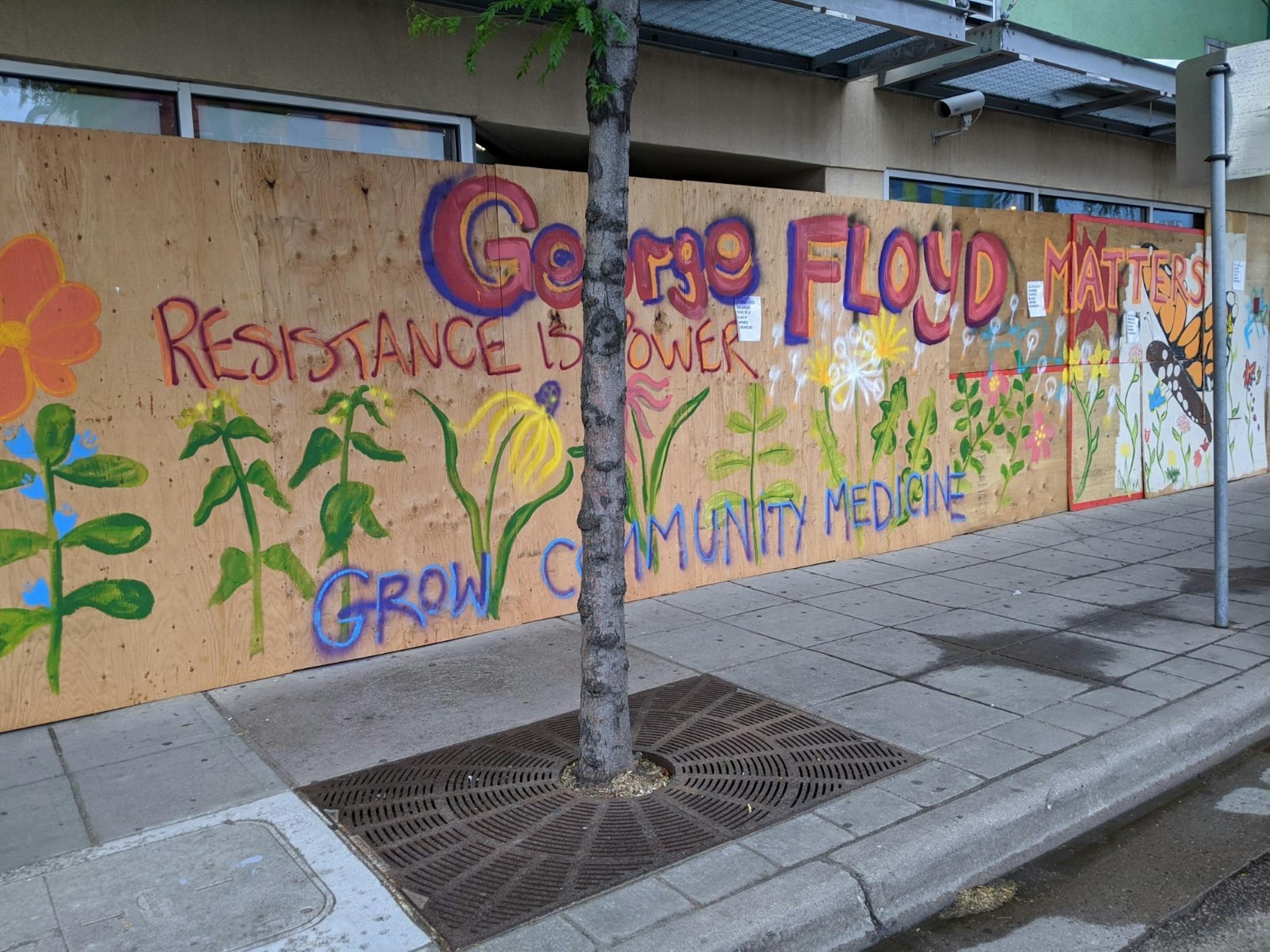 A mural across the boarded-up windows of Universal Health Solutions (1510 E. Lake St.) offers calls for resistance, community support, and solidarity in the wake of George FloydÕs killing by Minneapolis police.
