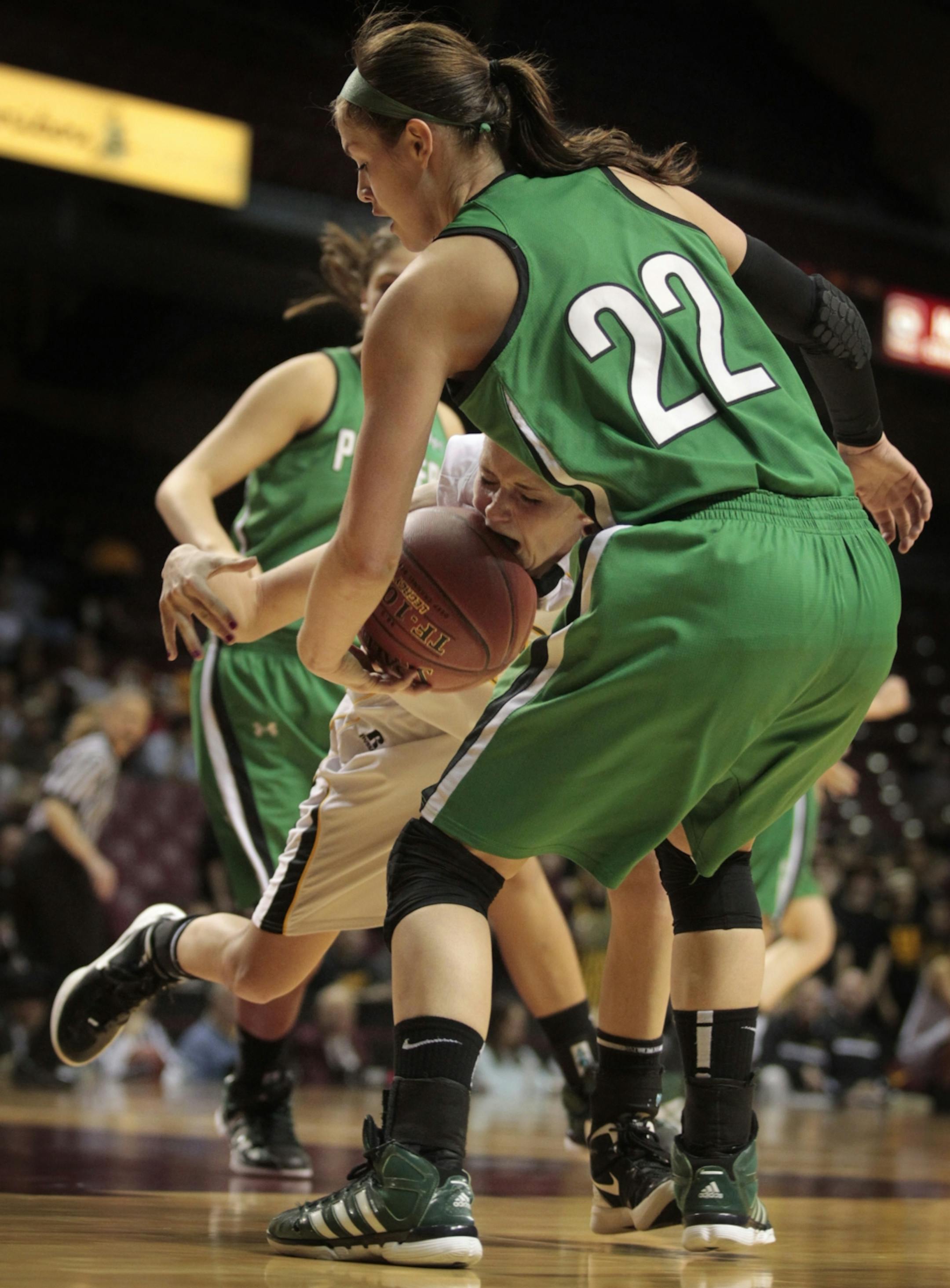Alissa Retterath of Hutchinson (in white) was fouled by Tessa Cichy of Hill-Murray. Cichy had a rough afternoon, scoring just 11 points — 11 below her average — on 4-for-17 shooting.