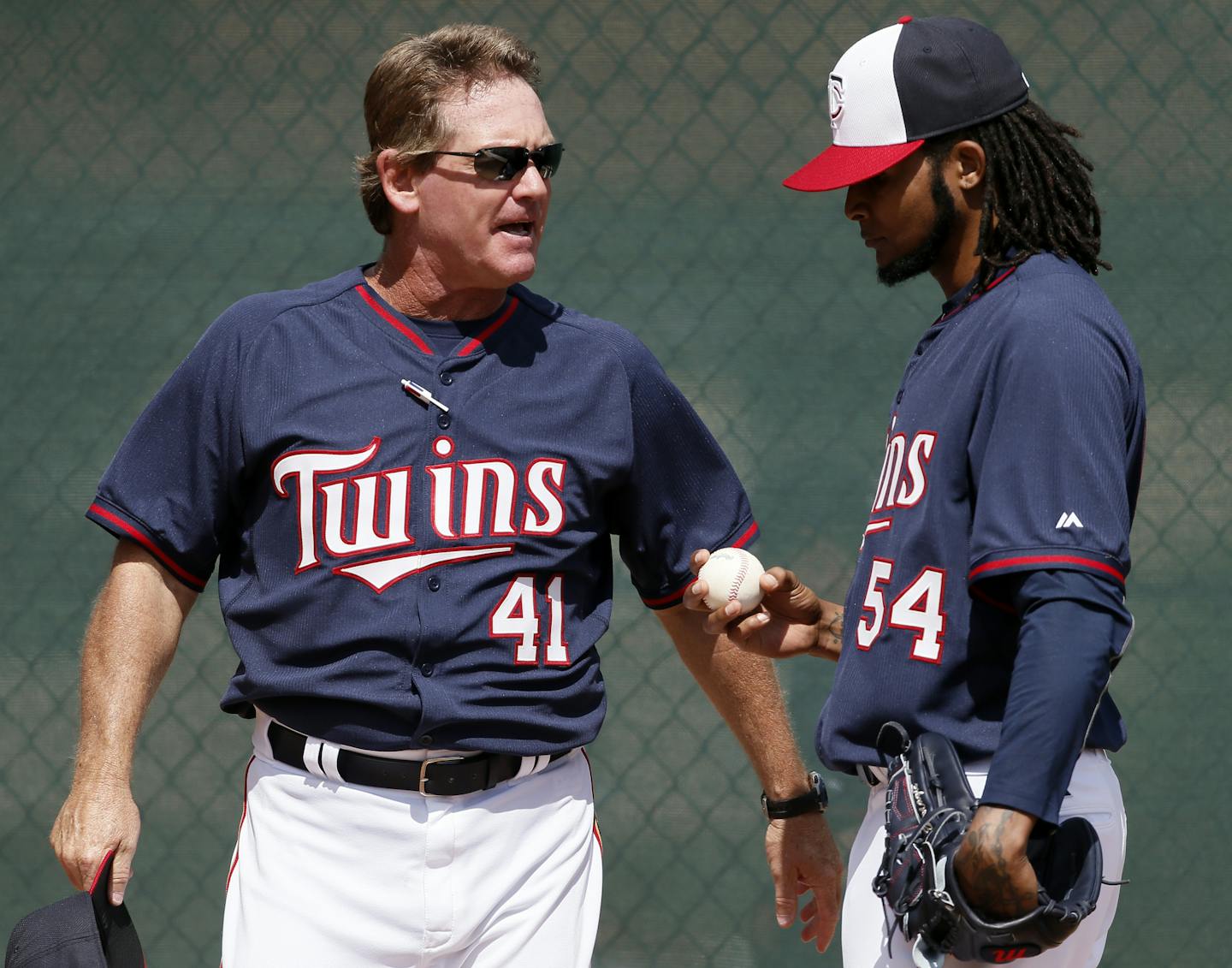 Minnesota Twins pitching coach Neil Allen (41) talks with Ervin Santana in the bullpen at spring training in Fort Myers.