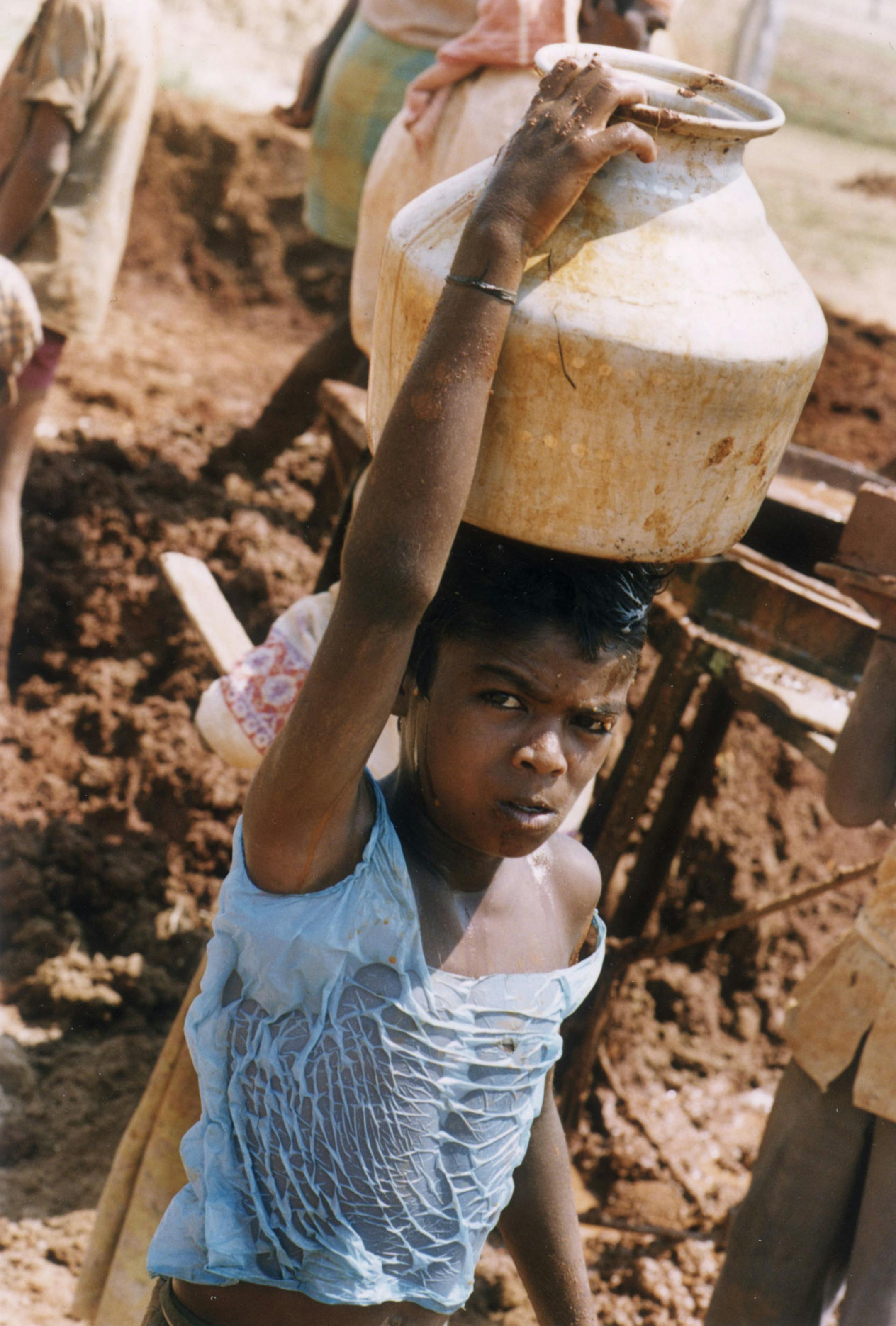 Boy carrying water in a brick Factory, near Mysore, India 1995. Photo by David Parker, a Minneapolis physician. ORG XMIT: MIN2013073110533724