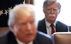National Security Advisor John Bolton looks on as President Donald Trump speaks to reporters during a meeting with his Cabinet, in the Cabinet Room of