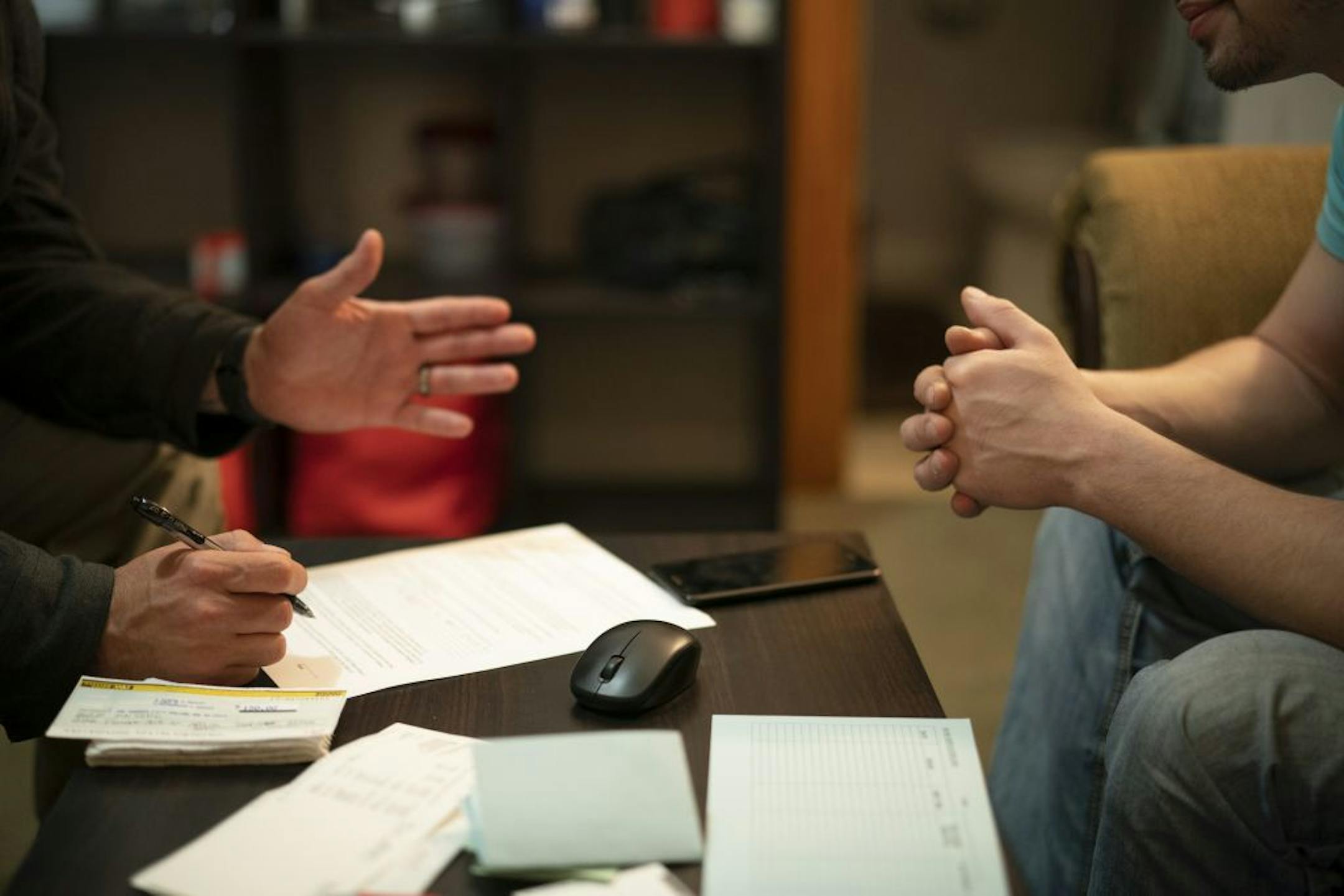 Former prison inmate Daniel and ISR Agent Ricardo Defiel talked in Daniel's north Minneapolis apartment during a random visit Monday night. Defiel and Daniel were completing paperwork for him to enter Phase III of his supervised release, which is the final six months of the program.