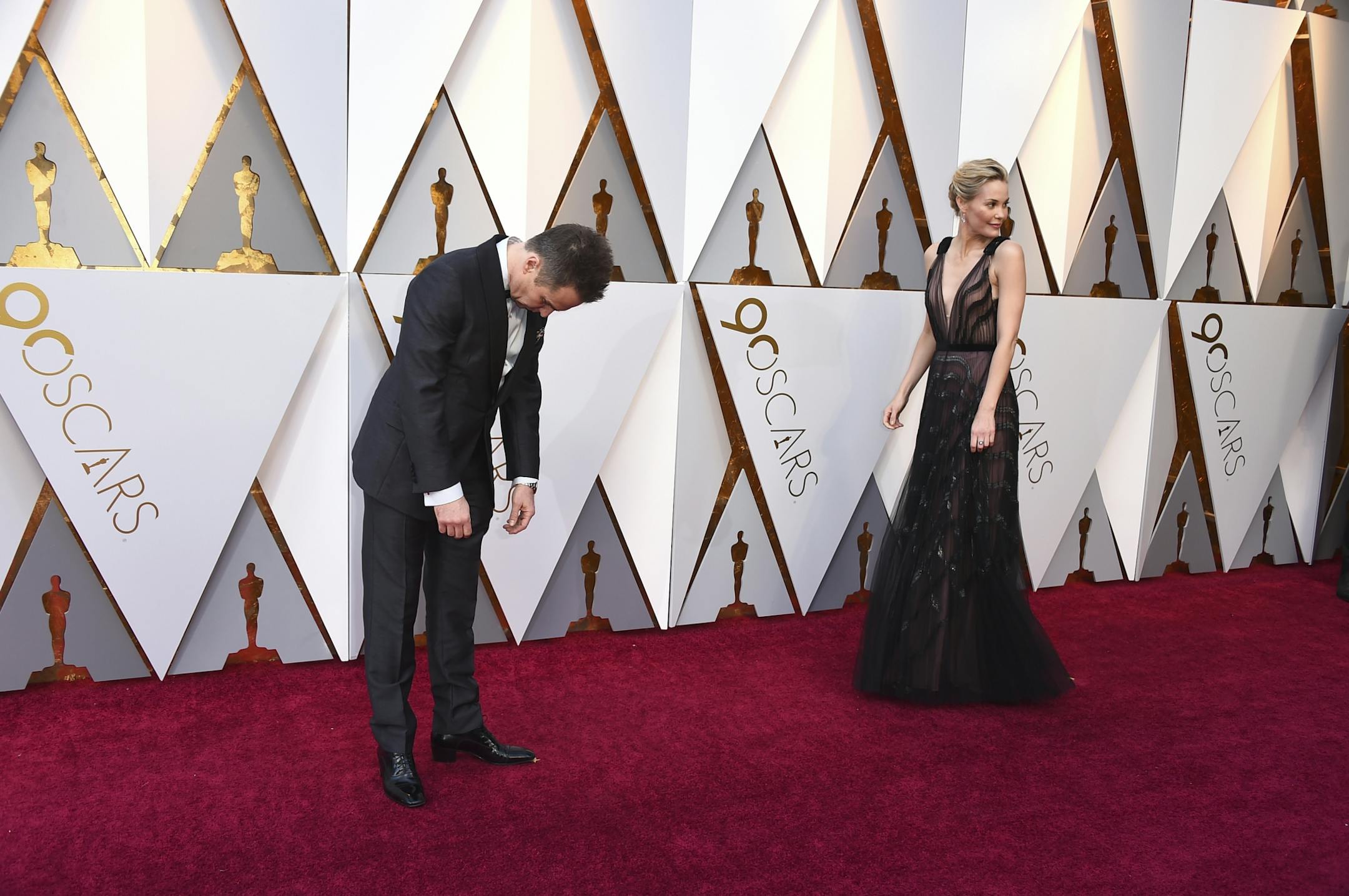 Sam Rockwell, left, and Leslie Bibb arrive at the Oscars on Sunday, March 4, 2018, at the Dolby Theatre in Los Angeles.