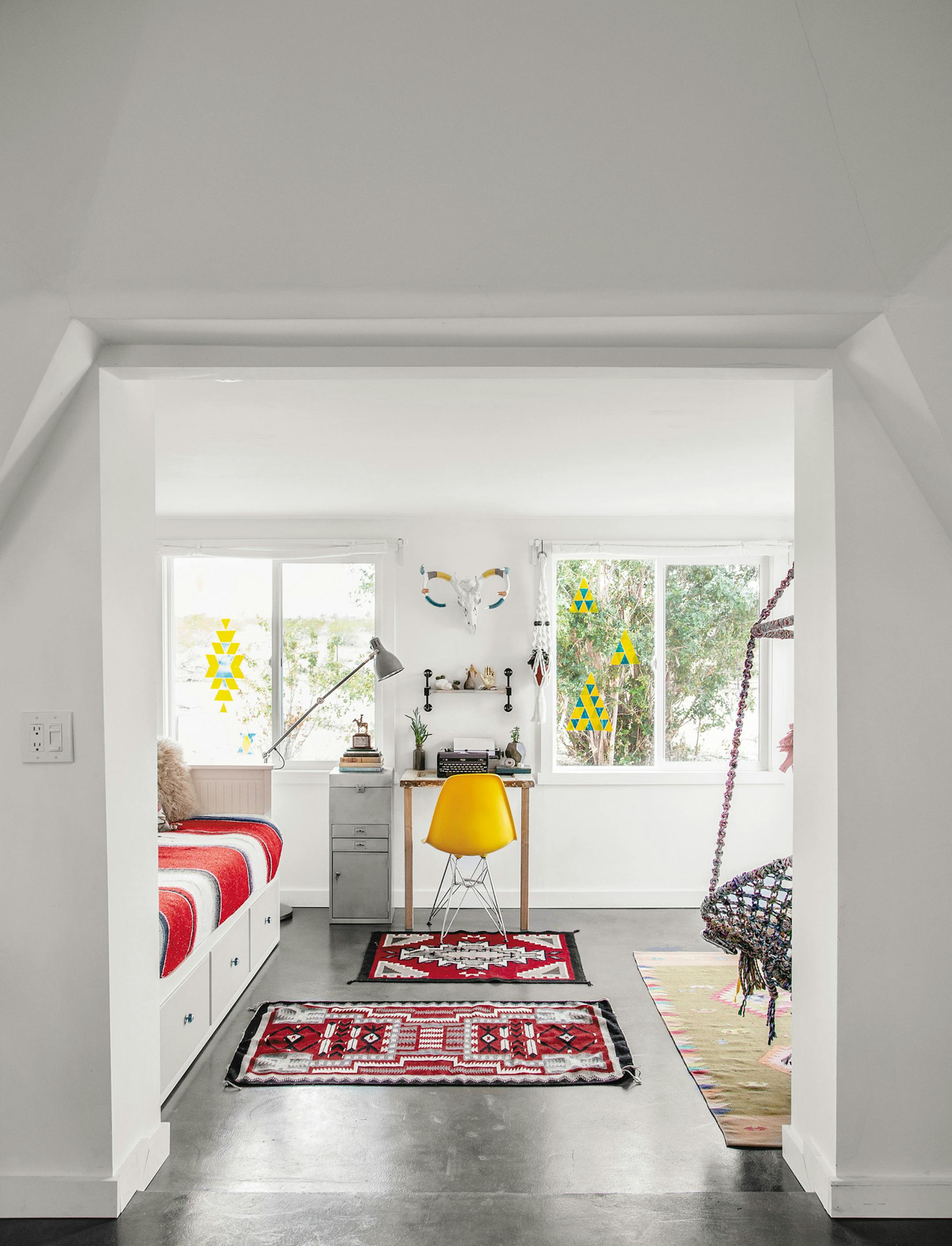Off the cool, contemporary-infused bedroom, an addition provides a space for writing, hanging out or resting.