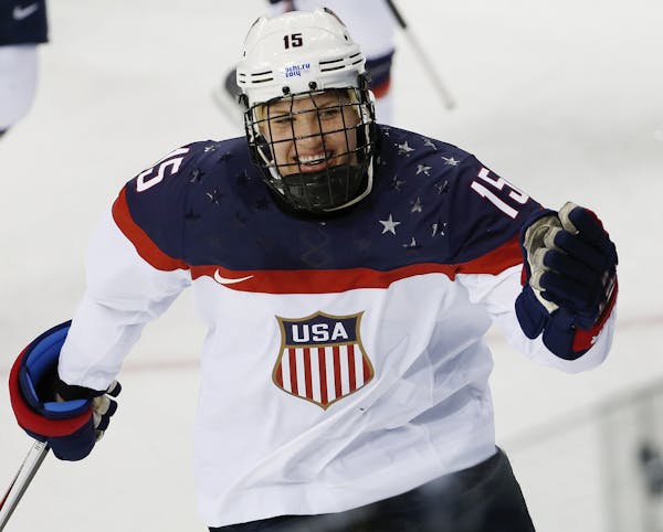Anne Schleper of the United States celebrates a goal against Canada during the second period of the 2014 Winter Olympics women's ice hockey game at Sh