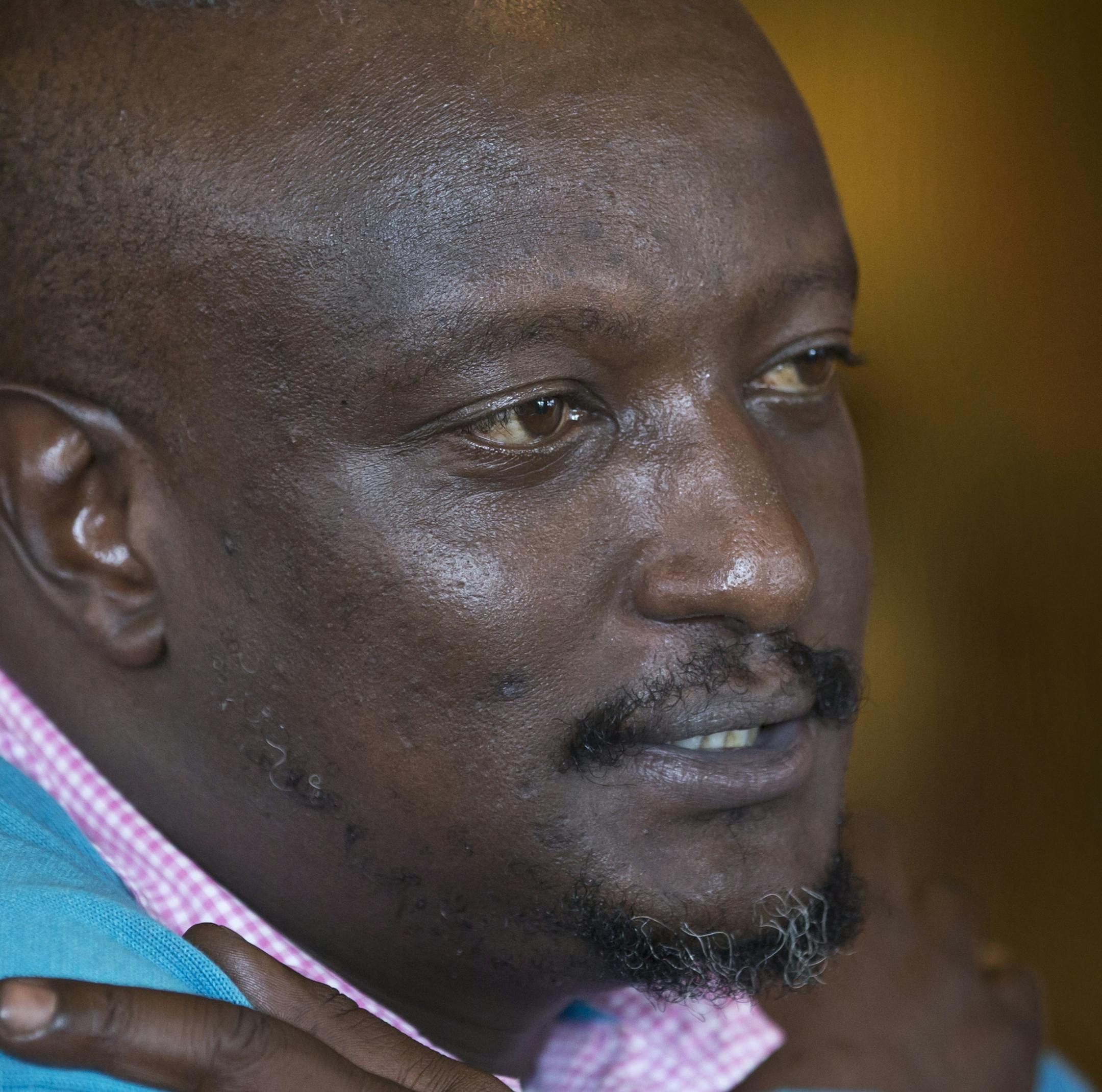 FILE - In this Wednesday, Jan. 22, 2014 file photo, prize-winning Kenyan author Binyavanga Wainaina talks during a television interview in Nairobi, Kenya. The chairman of the Kwani Trust which Wainaina founded said Wednesday, May 22, 2019 that the author and LGBT activist died Tuesday night in Nairobi. (AP Photo/Ben Curtis, File)