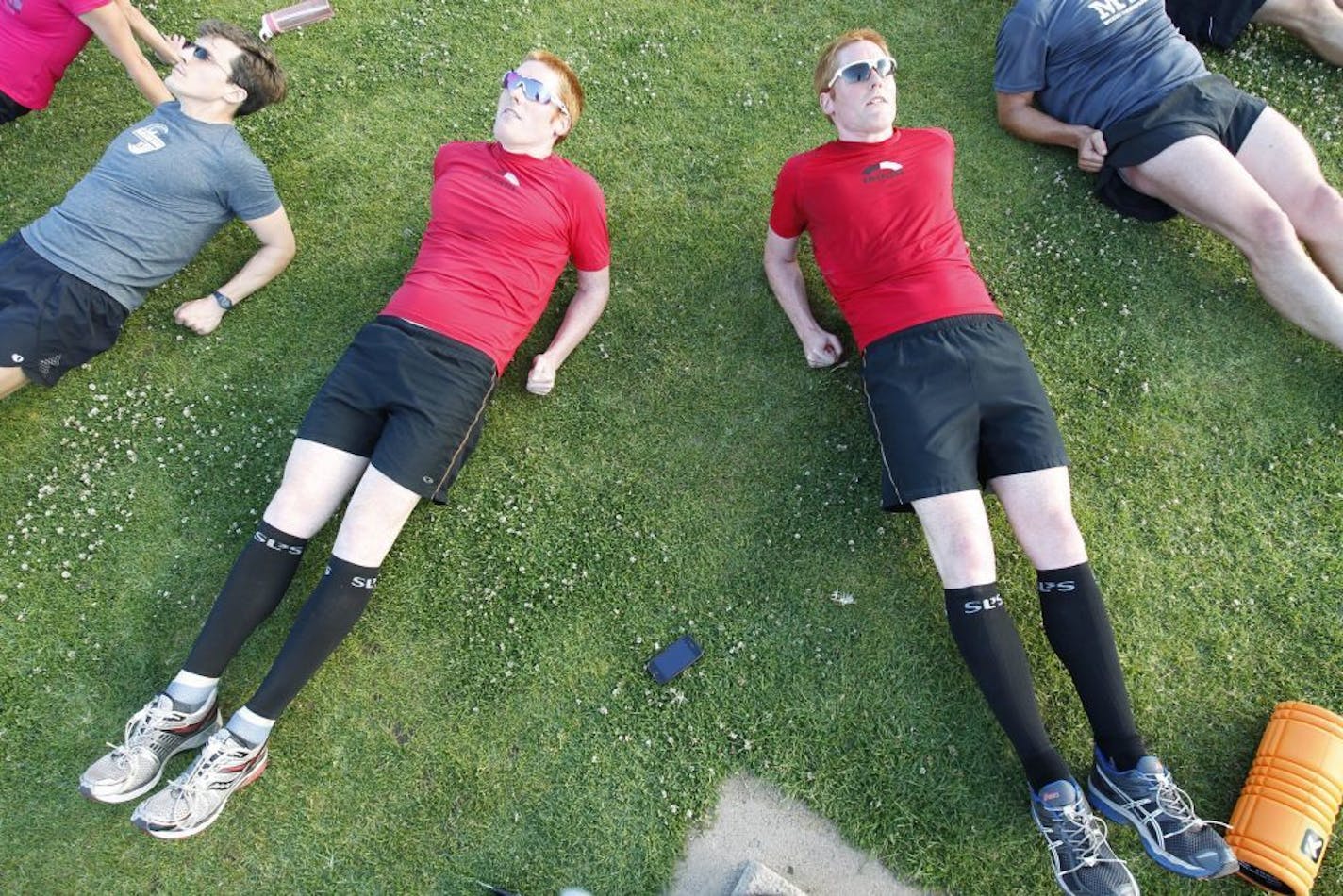 Twin brothers Thomas, left, and Andrew Roos, 28, work out with team members of the Stanford triathlon team at Stanford University, Cobb Track and Angel Field in Stanford, California, May 16, 2013. The brothers are learning about their DNA code.