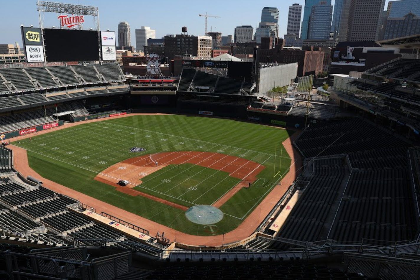 Groundskeepers worked to transform Target Field from a baseball to a football configuration in preparation for Saturday's game between the St. Thomas University Tommies and the St. Johns Johnnies.