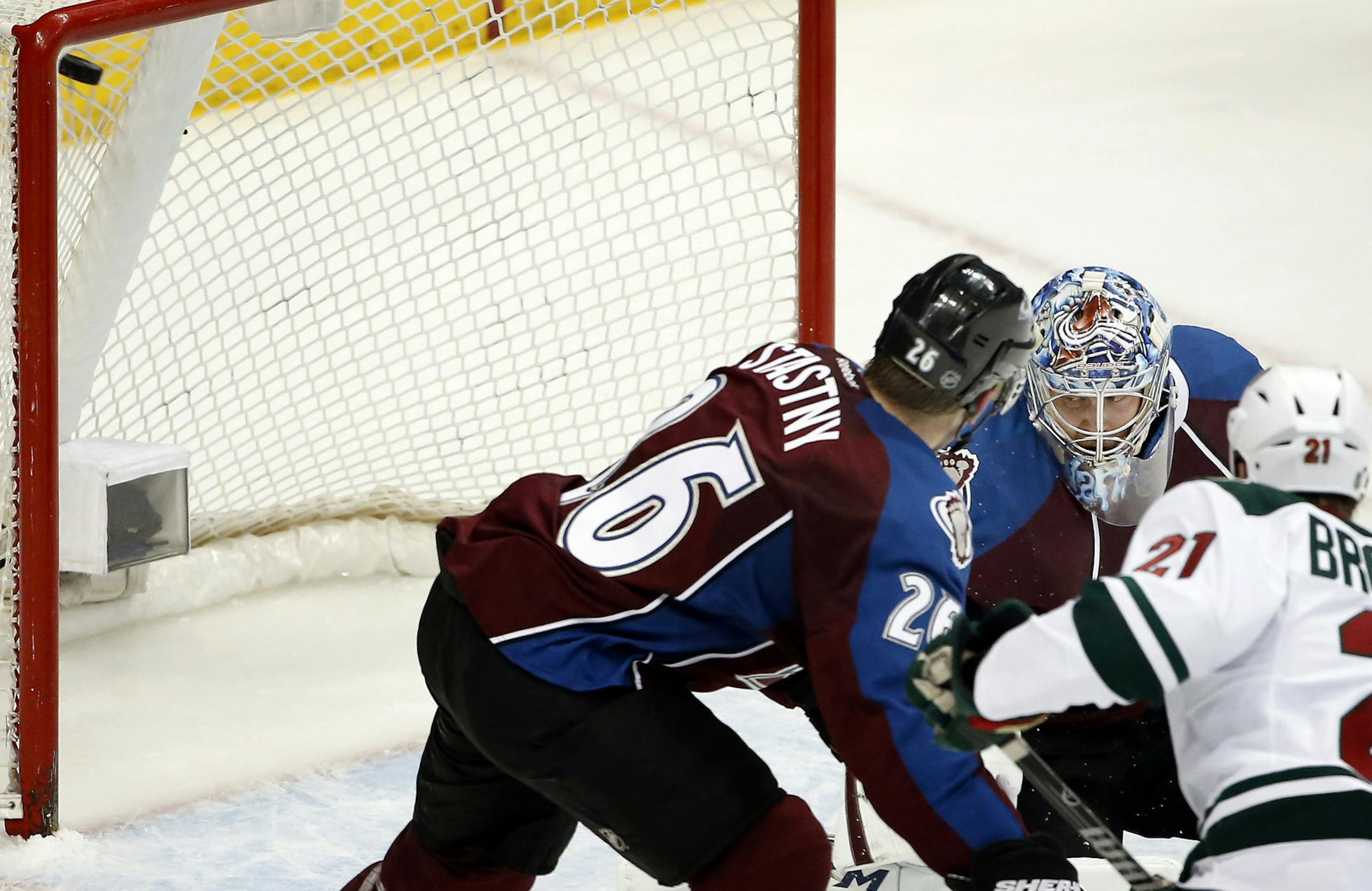 Kyle Brodziak (21) shot the puck past Colorado goalie Semyon Varlamov (1) for a goal in the second period. ] CARLOS GONZALEZ cgonzalez@startribune.com - April 17, 2014, Denver, Colorado, Pepsi Center, NHL, Minnesota Wild vs. Colorado Avalanche, Stanley Cup Playoffs round 1, Game 1