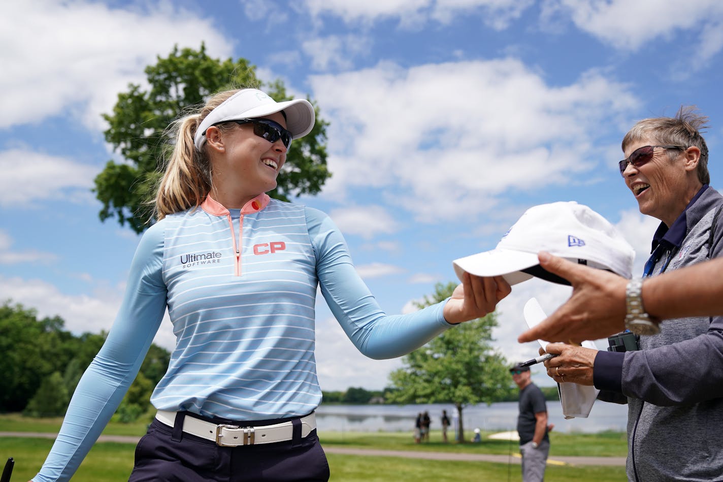 Brooke Henderson signed autographs for fans as she walked between holes Tuesday afternoon during the KPMG Women's PGA Championship pro-am.