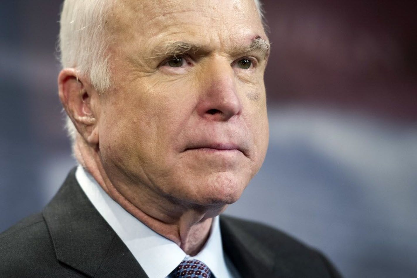 FILE - In this July 27, 2017, file photo, Sen. John McCain, R-Ariz., speaks to reporters on Capitol Hill in Washington. Legislative budget analysts say a possibly doomed Republican health care bill would mean a first-year loss of $1.7 billion of funding for Arizona for the Medicaid eligibility expansion and the health exchange. McCain says on Friday, Sept. 22, 2017, he won't vote for the Republican bill repealing the Obama health care law. His statement likely deals a fatal blow to the last-gasp