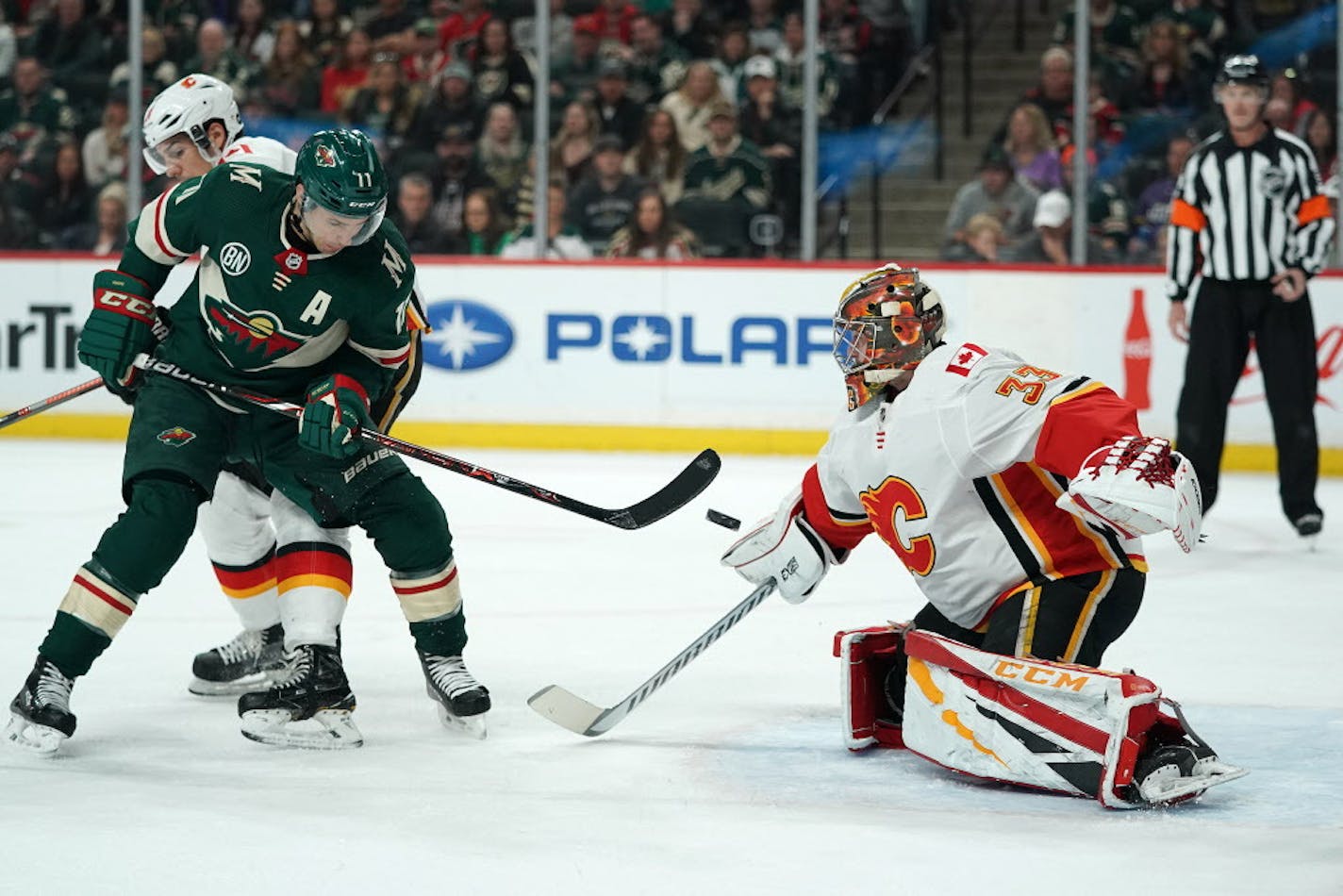 Minnesota Wild left wing Zach Parise (11) tried to deflect the puck past Calgary Flames goaltender David Rittich (33) in the first period. ] ANTHONY SOUFFLE &#xef; anthony.souffle@startribune.com The Minnesota Wild played the Calgary Flames in an NHL game Saturday, Dec. 15, 2018 at the Xcel Energy Center in St. Paul, Minn.