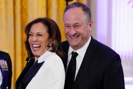 Vice President Kamala Harris, left, and second gentleman Doug Emhoff arrive in the East Room of the White House, Feb. 11, 2023, in Washington.