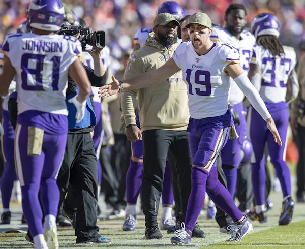 Vikings wide receiver Adam Thielen celebrated from the sideline with wide receiver Bisi Johnson after his touchdown in the fourth quarter. ] ELIZABETH