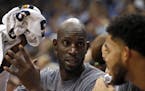 FILE - In this Nov. 15, 2015, file photo, Minnesota Timberwolves forward Kevin Garnett, left, talks with Karl-Anthony Towns, right, during the second 