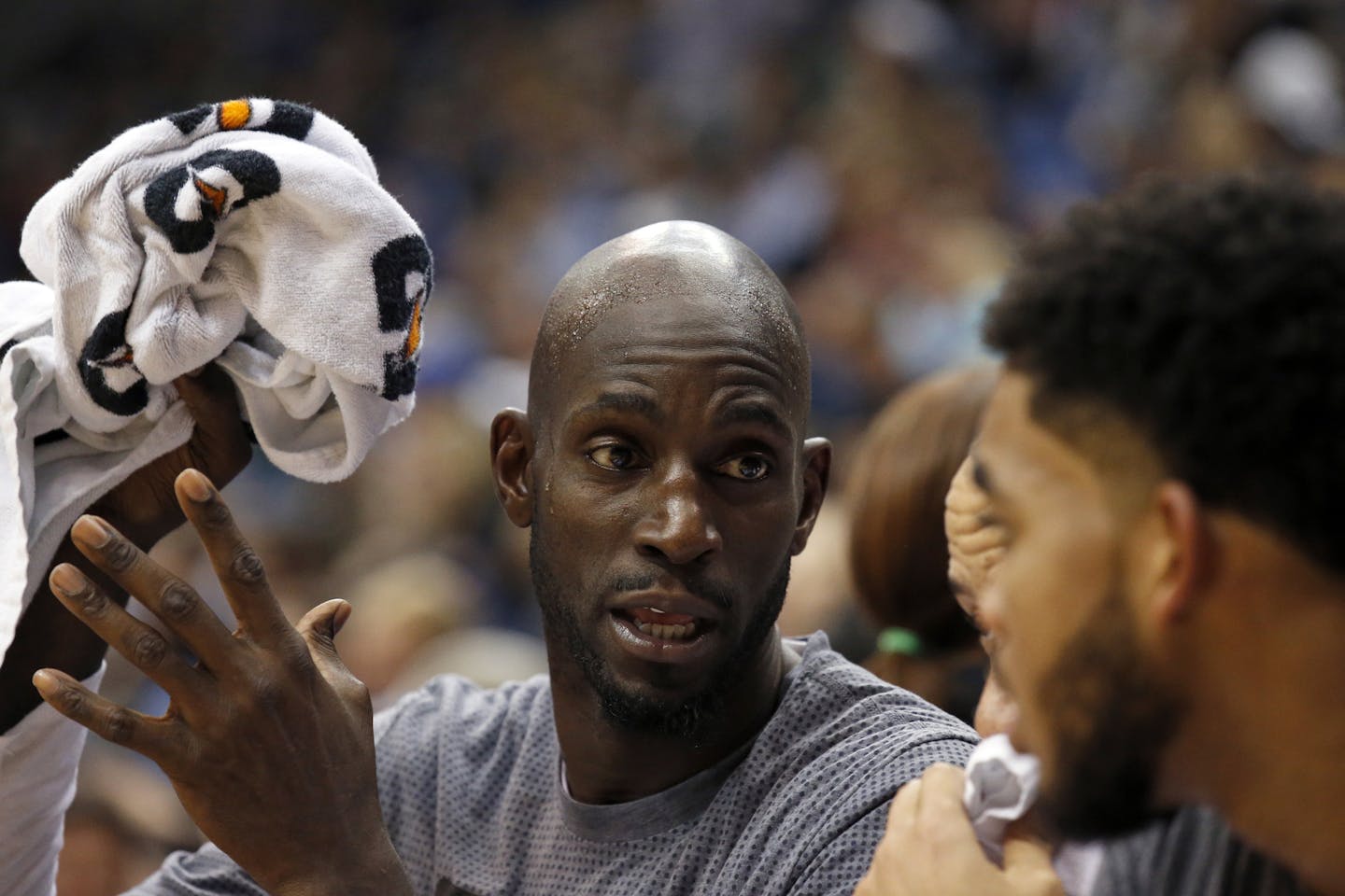 FILE - In this Nov. 15, 2015, file photo, Minnesota Timberwolves forward Kevin Garnett, left, talks with Karl-Anthony Towns, right, during the second half of an NBA basketball game against the Memphis Grizzlies in Minneapolis. Cleveland Cavaliers coach Tyronn Lue says he's got a coaching spot available on his staff for Kevin Garnett if the former NBA star wants it. A 15-time NBA All-Star, Garnett recently retired after 21 seasons. The 40-year-old Garnett and Lue are close friends. (AP Photo/Ann