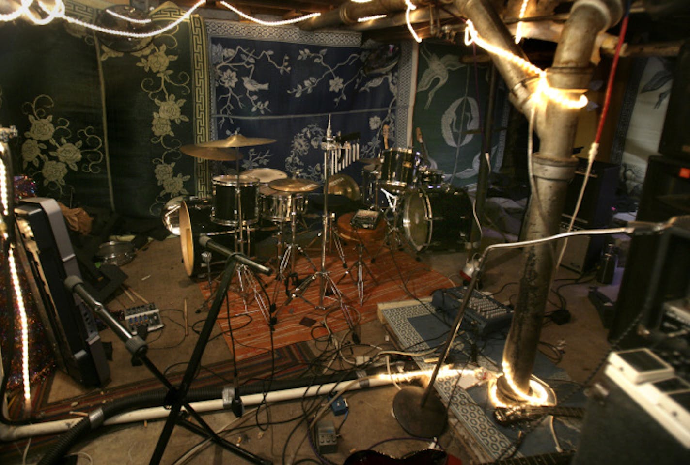 This is a "punk house" where six 20-year-old musicians live communally in a really messy place. Basement rehersal space.