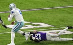 Dallas Cowboys quarterback Dak Prescott (4) rushes the ball as Minnesota Vikings cornerback Andrew Booth Jr. (23) goes down for the tackle in the seco