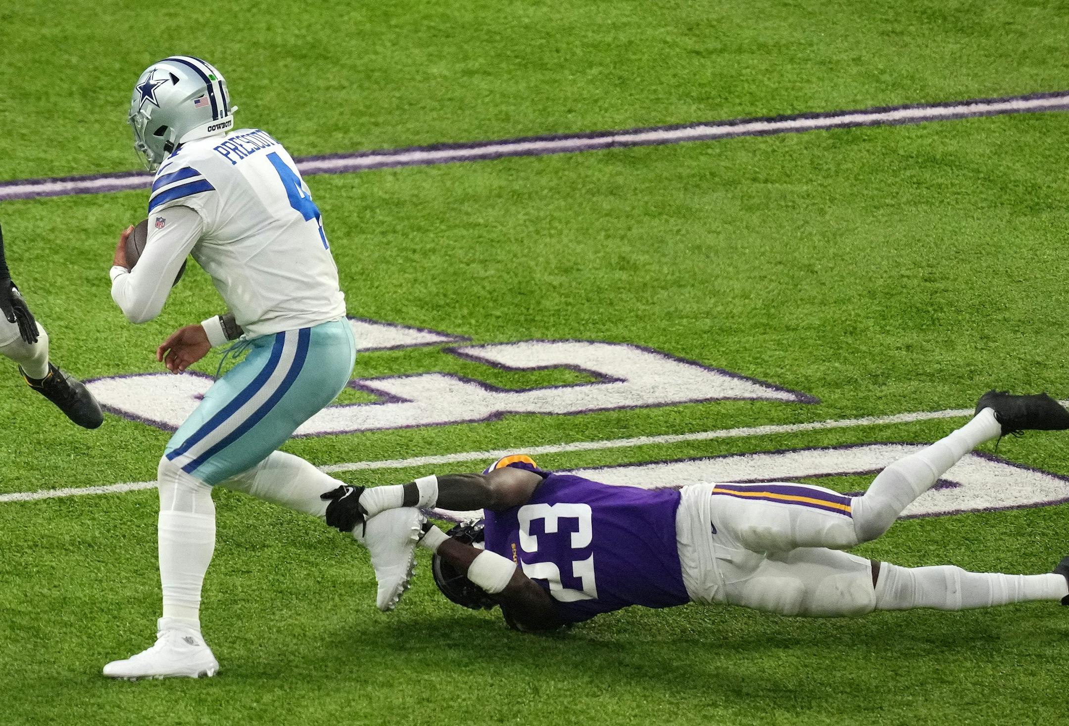 Dallas Cowboys quarterback Dak Prescott (4) rushes the ball as Minnesota Vikings cornerback Andrew Booth Jr. (23) goes down for the tackle in the second quarter of an NFL game between the Minnesota Vikings and the Dallas Cowboys Sunday, Nov. 20, 2022 at U.S. Bank Stadium in Minneapolis. ] ANTHONY SOUFFLE • anthony.souffle@startribune.com