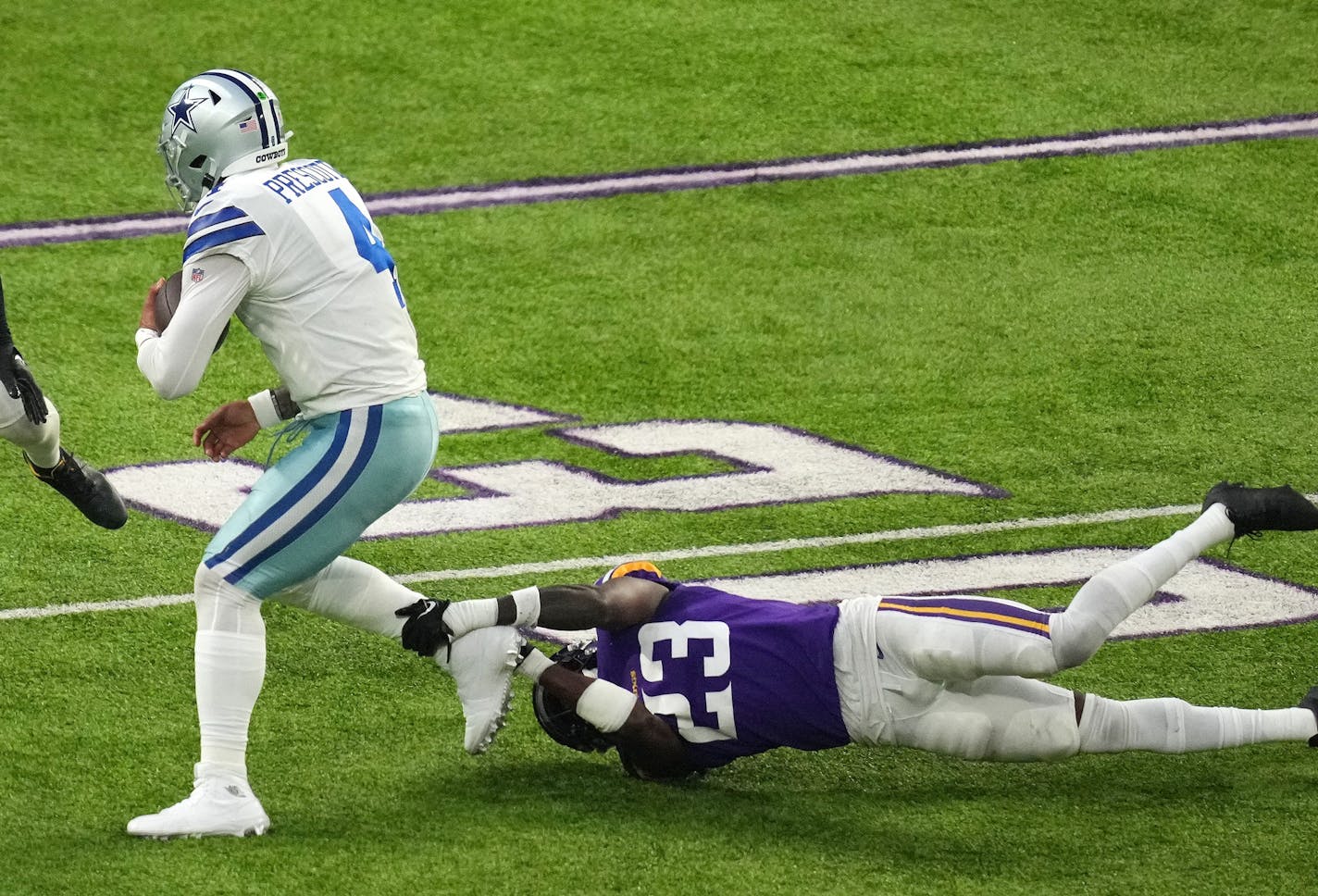 Dallas Cowboys quarterback Dak Prescott (4) rushes the ball as Minnesota Vikings cornerback Andrew Booth Jr. (23) goes down for the tackle in the second quarter of an NFL game between the Minnesota Vikings and the Dallas Cowboys Sunday, Nov. 20, 2022 at U.S. Bank Stadium in Minneapolis. ] ANTHONY SOUFFLE • anthony.souffle@startribune.com