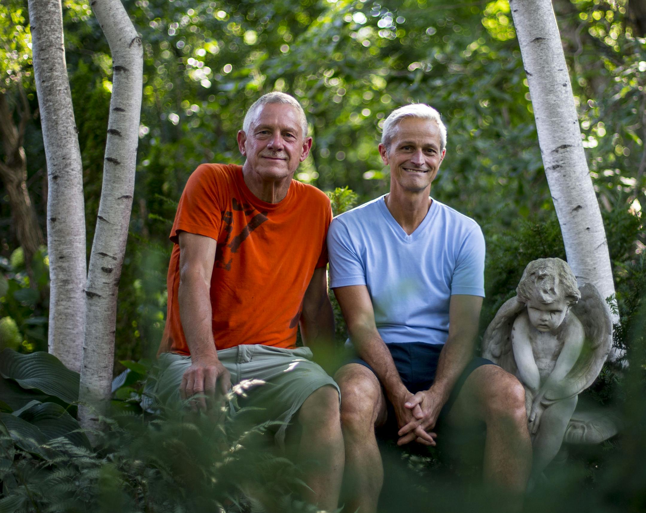 Tom Hayden and Jay Peterson sat on a stone bench in a grove of birch trees in their garden. Top, a moongate frames views of a statue in the backyard.
