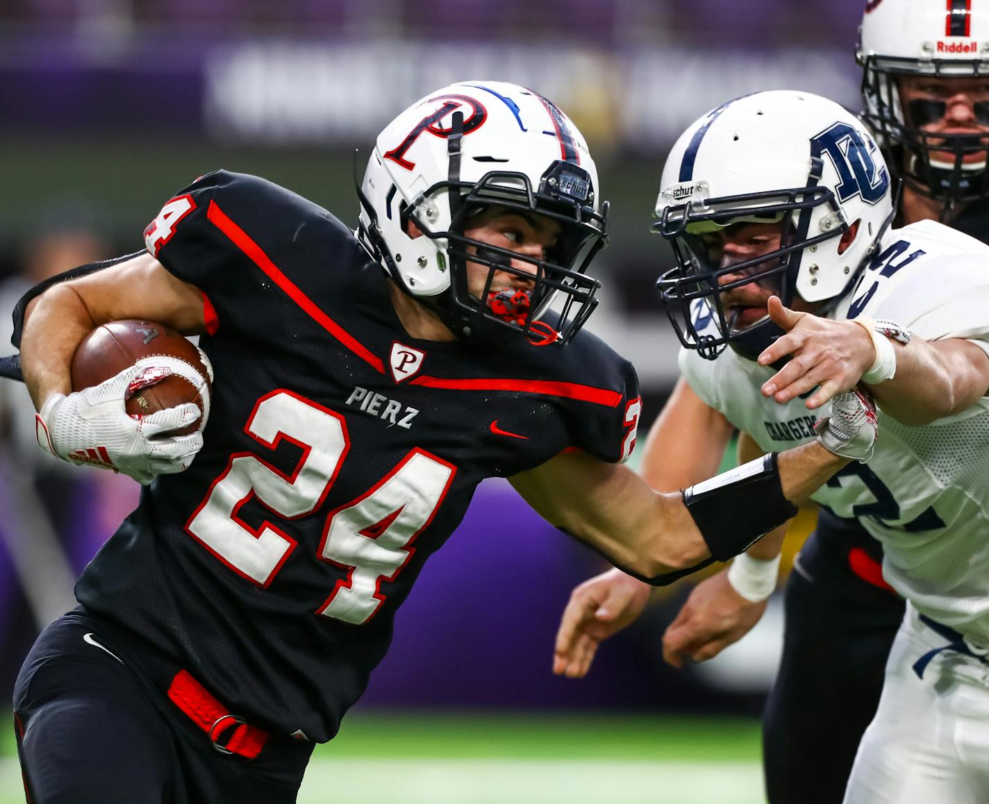 Pierz Pioneers running back Matthias Algarin (24) runs with the ball against Dassel-Cokato Chargers defensive lineman Teddy Bergquist (52) in the second quarter. ] David Berding &#x2022; Special to the Star Tribune Pierz played Dassel-Cokato in the Class 3A State Tournament Championship game on Saturday, November 30, 2019 at US Bank Stadium in Minneapolis, Minnesota.