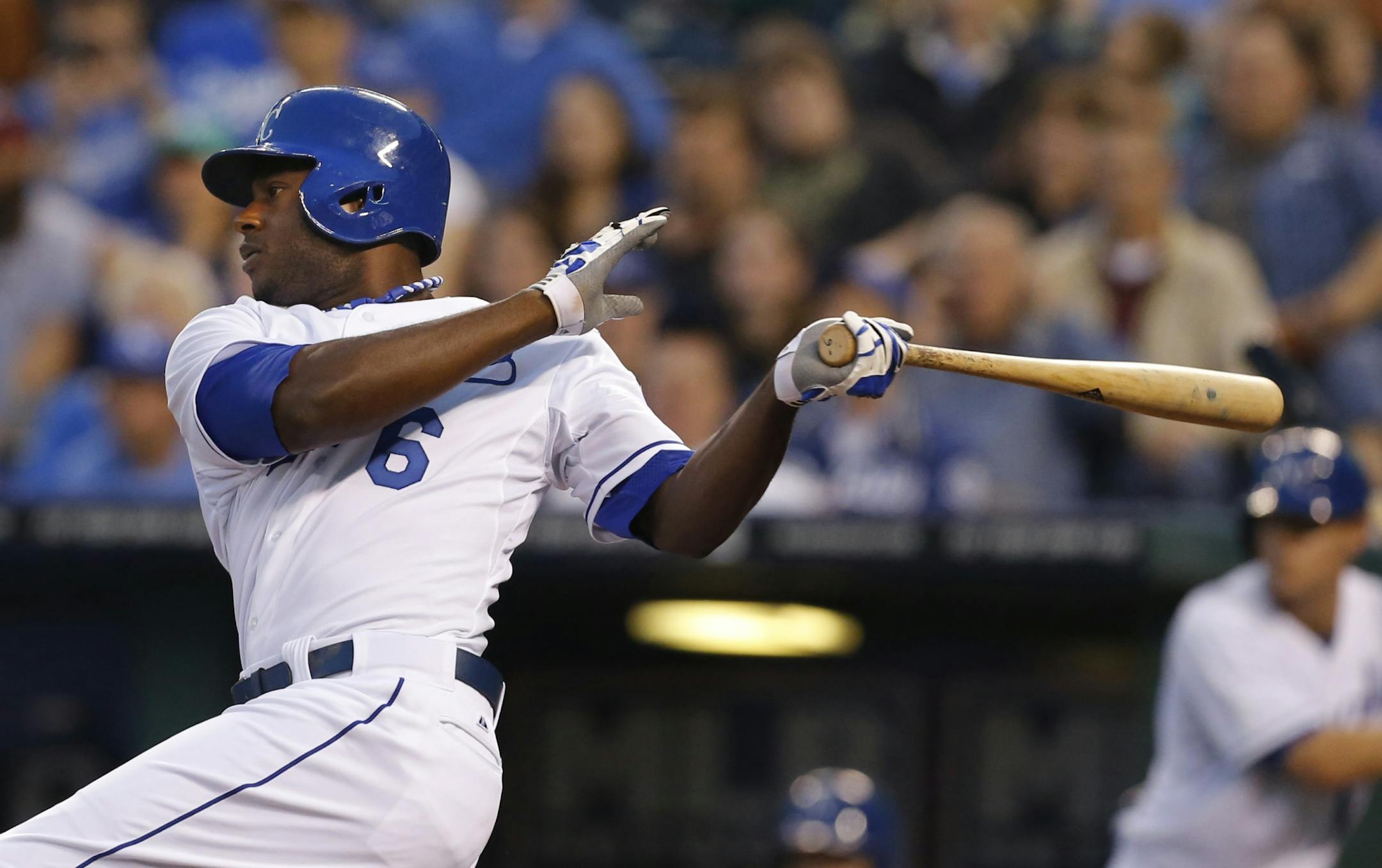 Kansas City Royals' Lorenzo Cain (6) drives in teammate Salvador Perez during the first inning of a baseball game against the Minnesota Twins at Kauffman Stadium in Kansas City, Mo., Tuesday, April 9, 2013.